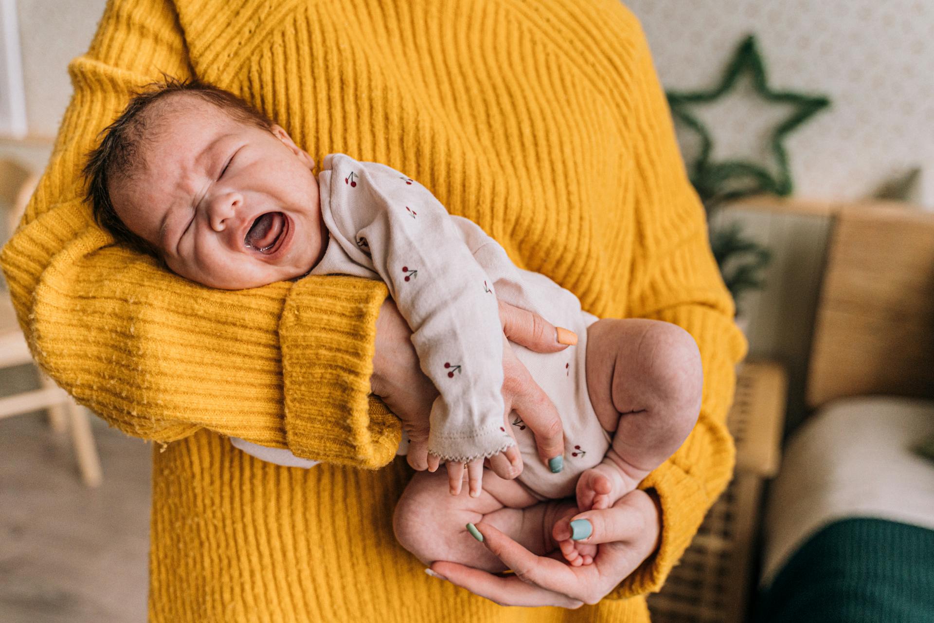 A mother holding her newborn baby | Source: Pexels