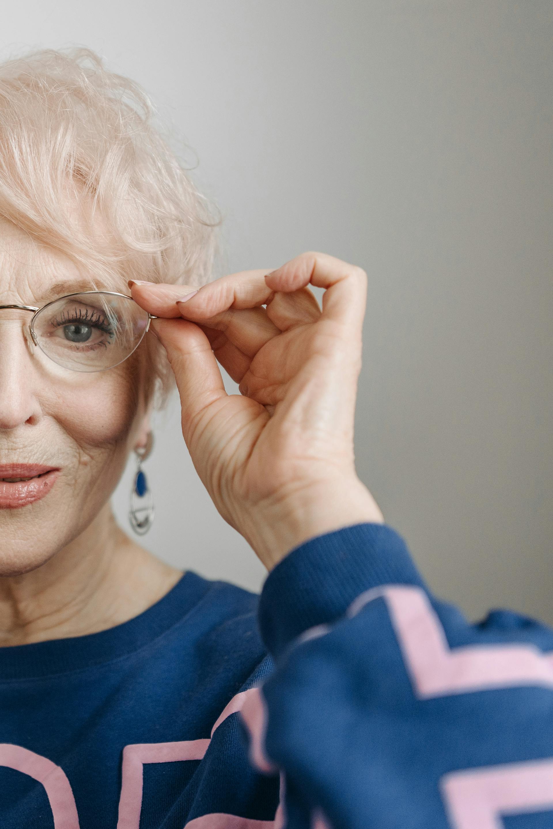 A close-up shot of an elderly woman touching her eyeglasses | Source: Pexels