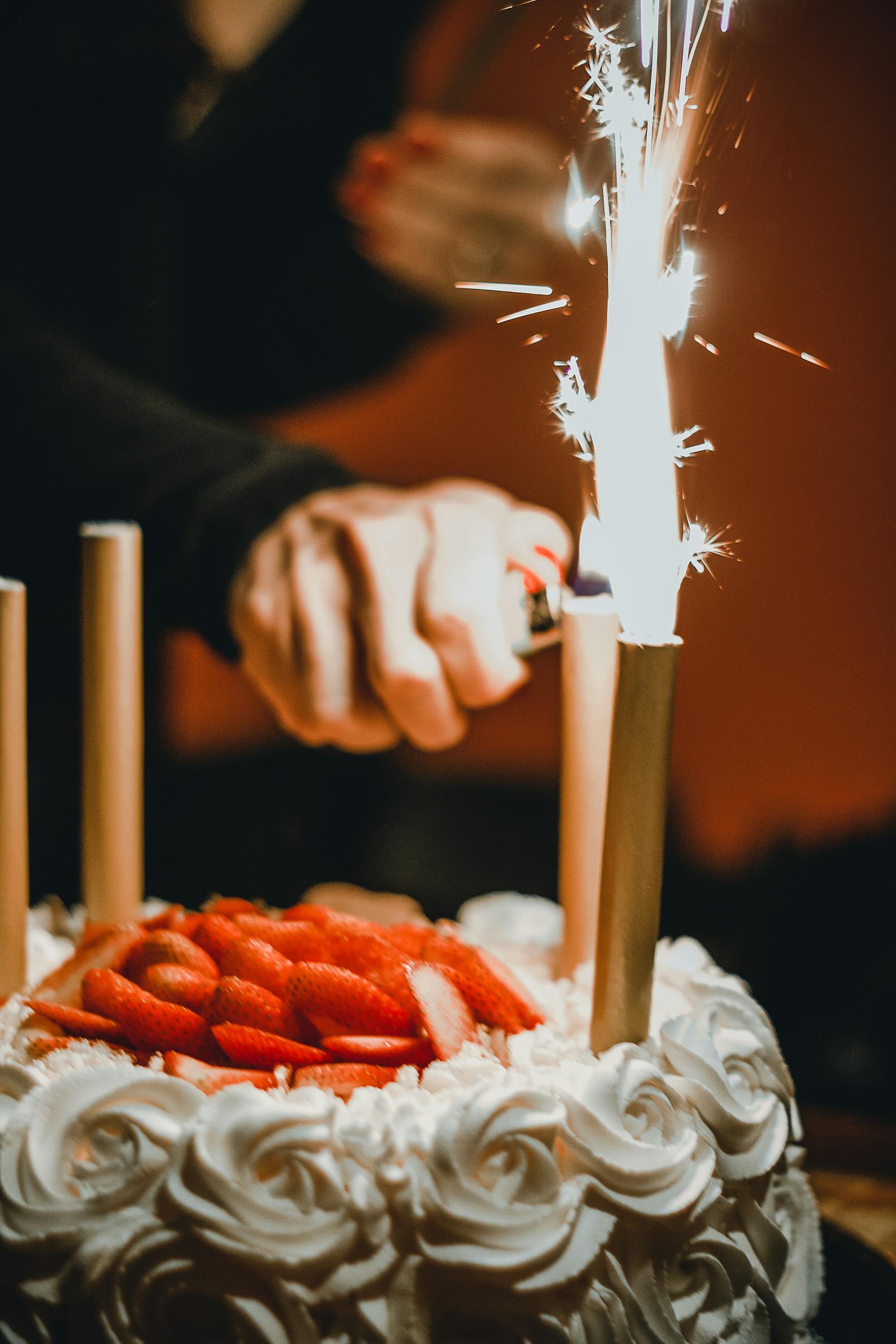 Someone lighting the candles on a birthday cake | Source: Pexels