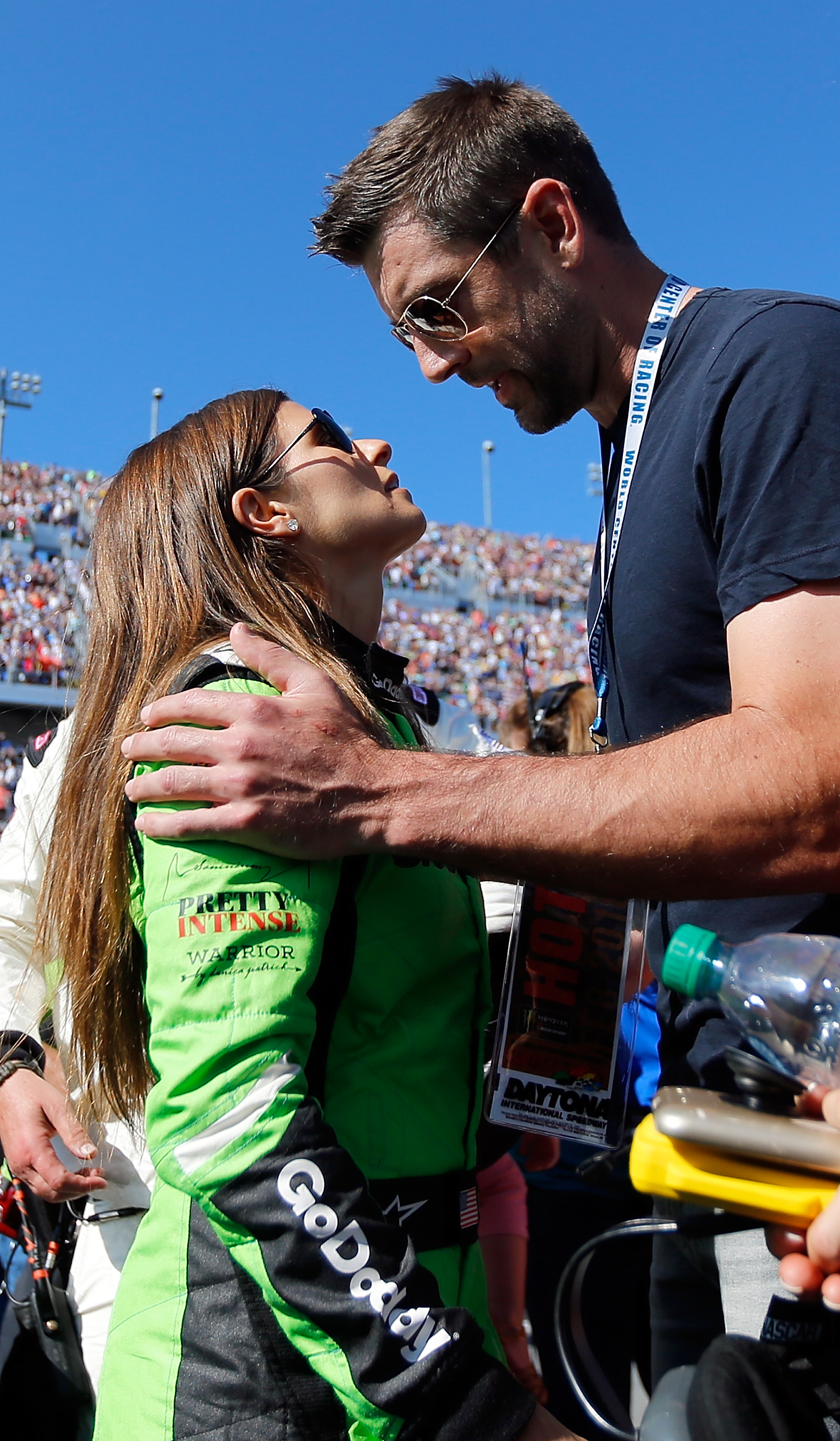 Danica Patrick, driver of the #7 GoDaddy Chevrolet, stands with Aaron Rodgers, quarterback for the Green Bay Packers, on the grid prior to the Monster Energy NASCAR Cup Series 60th Annual Daytona 500 at Daytona International Speedway on February 18, 2018 in Daytona Beach, Florida. | Source: Getty Images