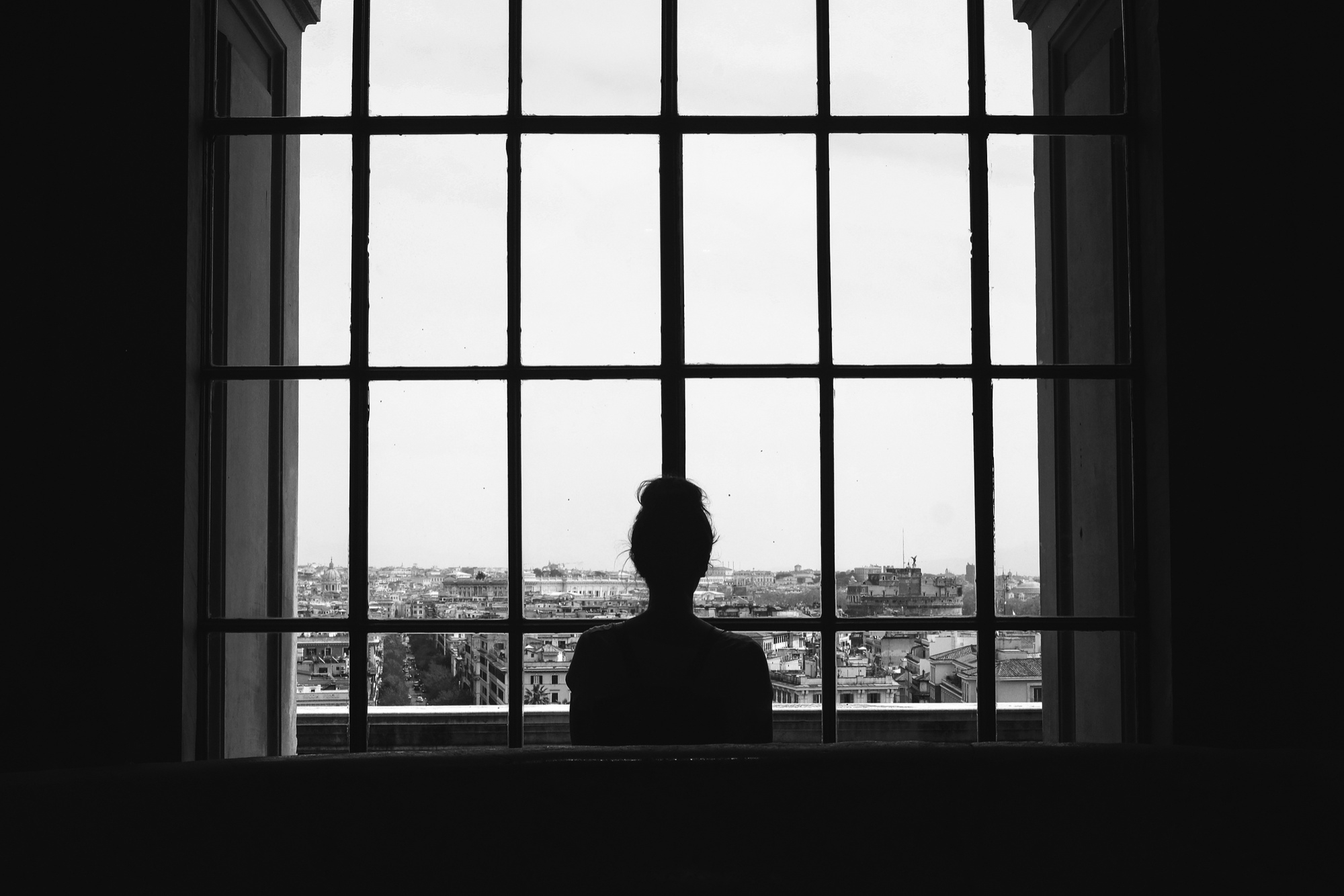 A woman standing near a window | Source: Freepik