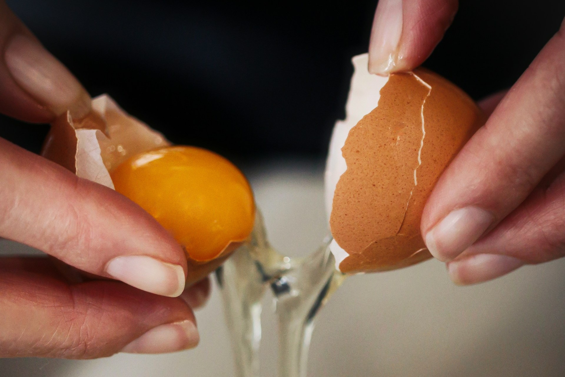 A woman breaking an egg | Source: Unsplash