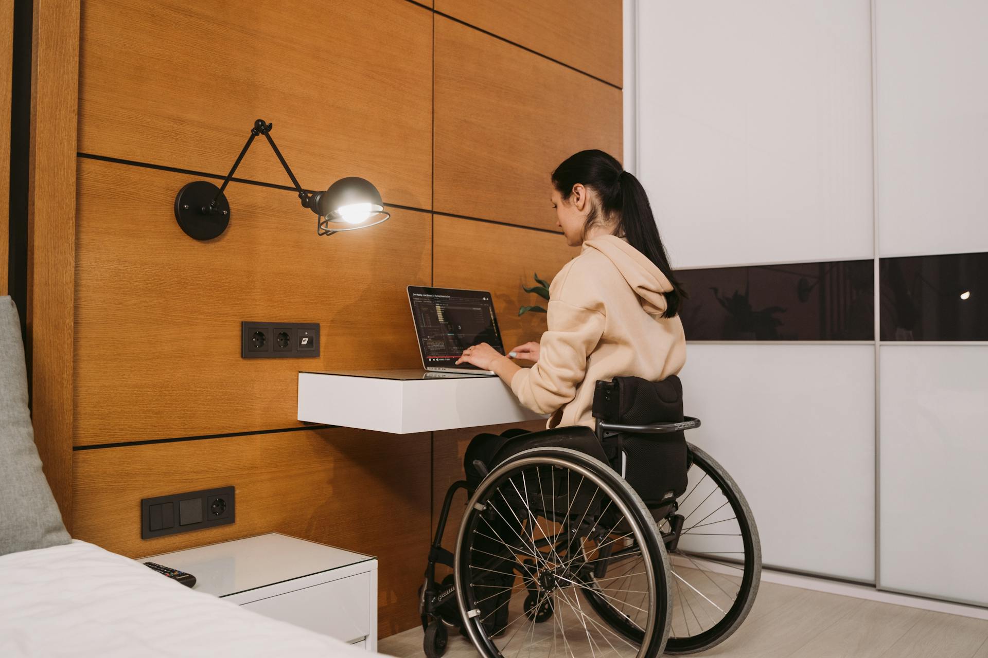 A woman sitting on her wheelchair and using her laptop | Source: Pexels