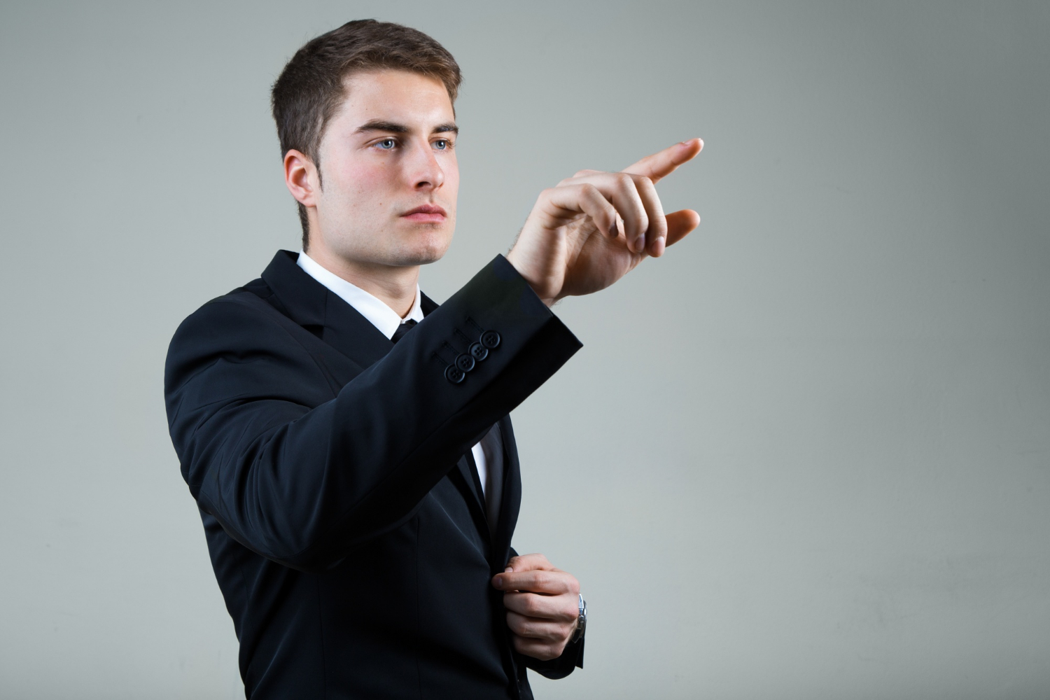 A man in an elegant suit pointing his finger | Source: Freepik