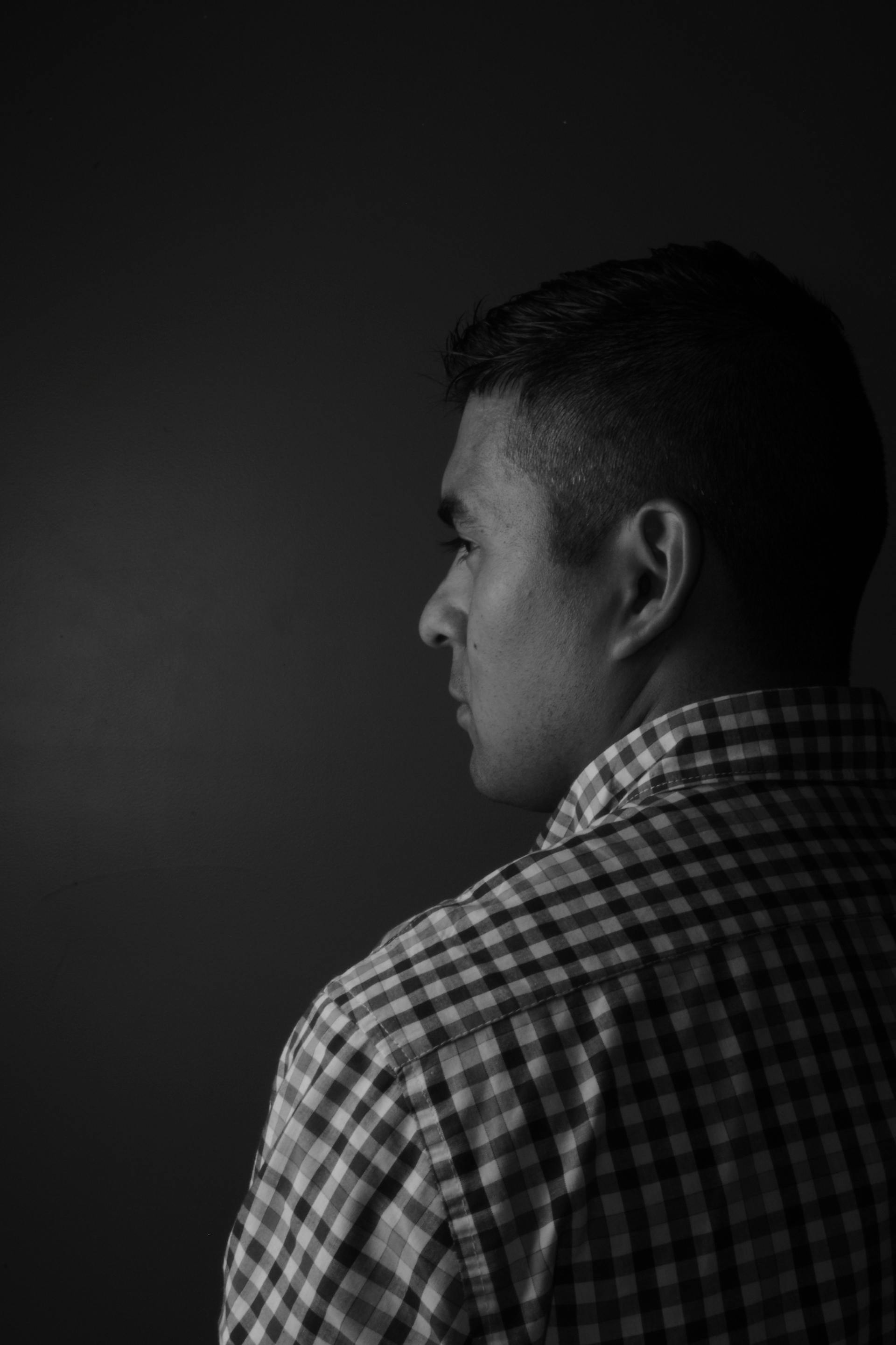 A back view of a man wearing a plaid shirt | Source: Pexels