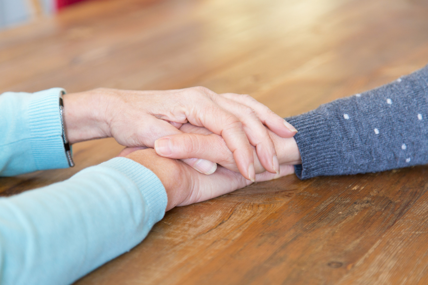 A senior woman holding a young lady's hand | Source: Freepik
