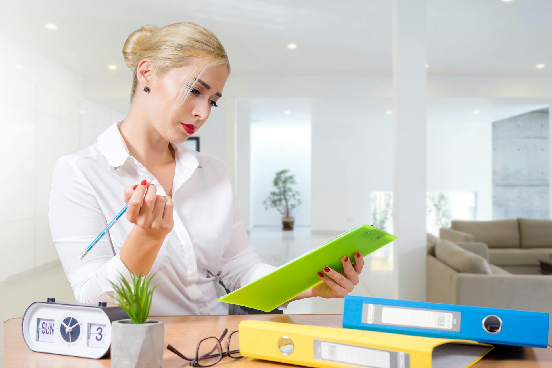 A female receptionist looking at a schedule while standing behind a desk | Source: Pexels