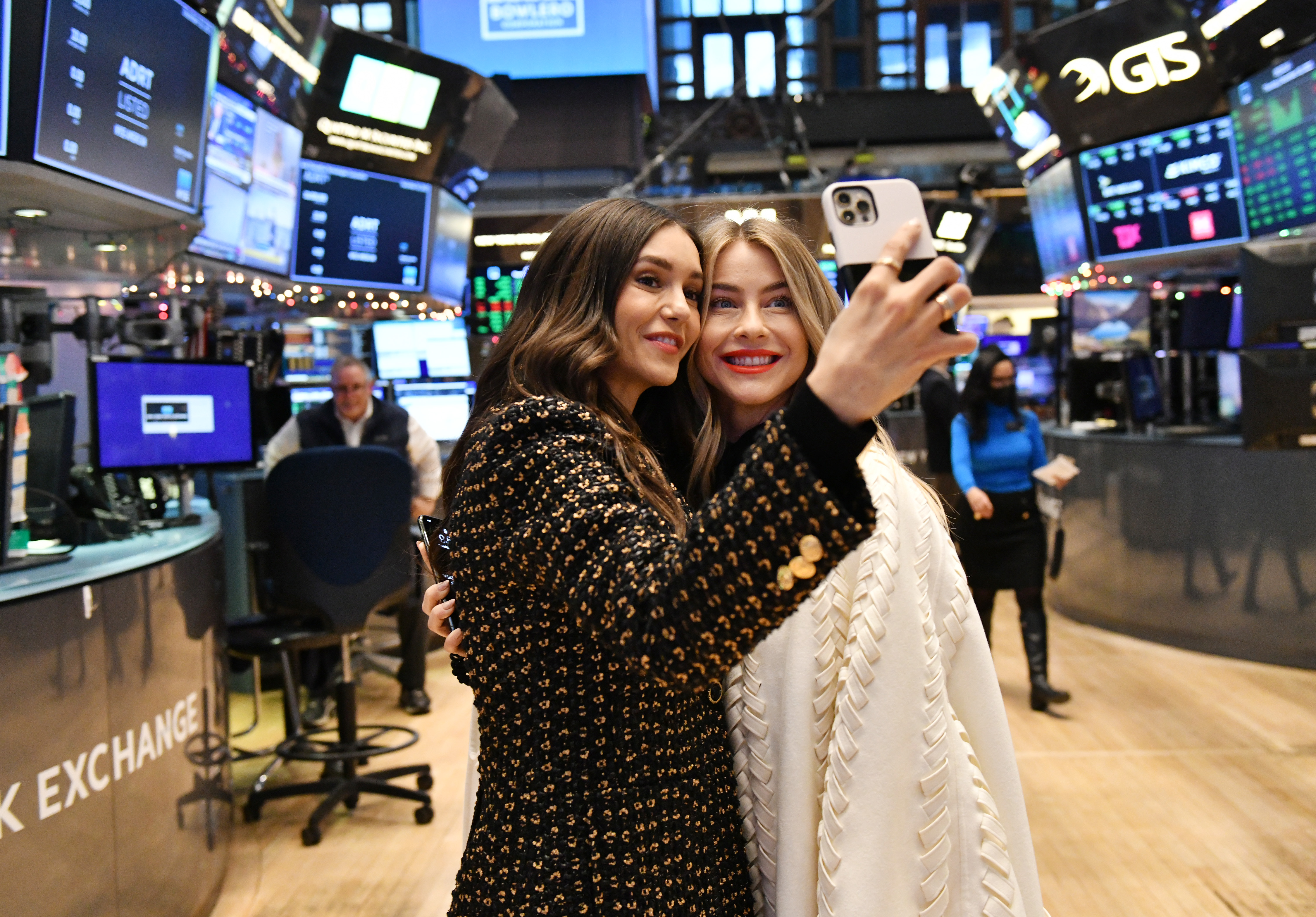 Nina Dobrev and Julianne Hough visit the floor of the New York Stock Exchange celebrating their company's Initial Public Offering on December 16, 2021, in New York. | Source: Getty Images