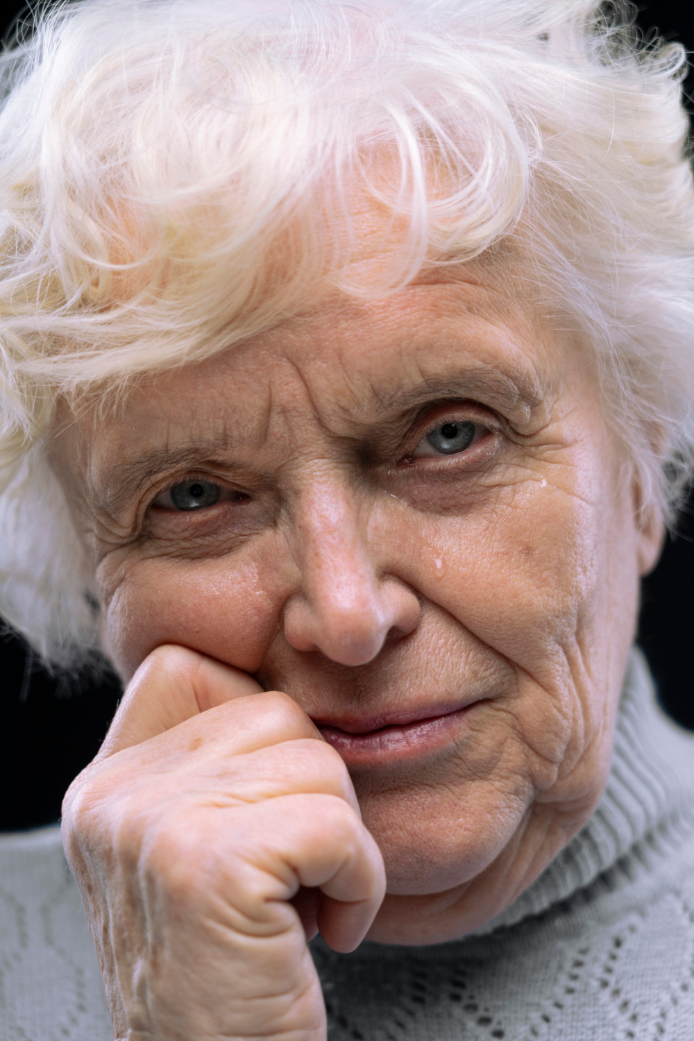 A teary-eyed older woman | Source: Freepik