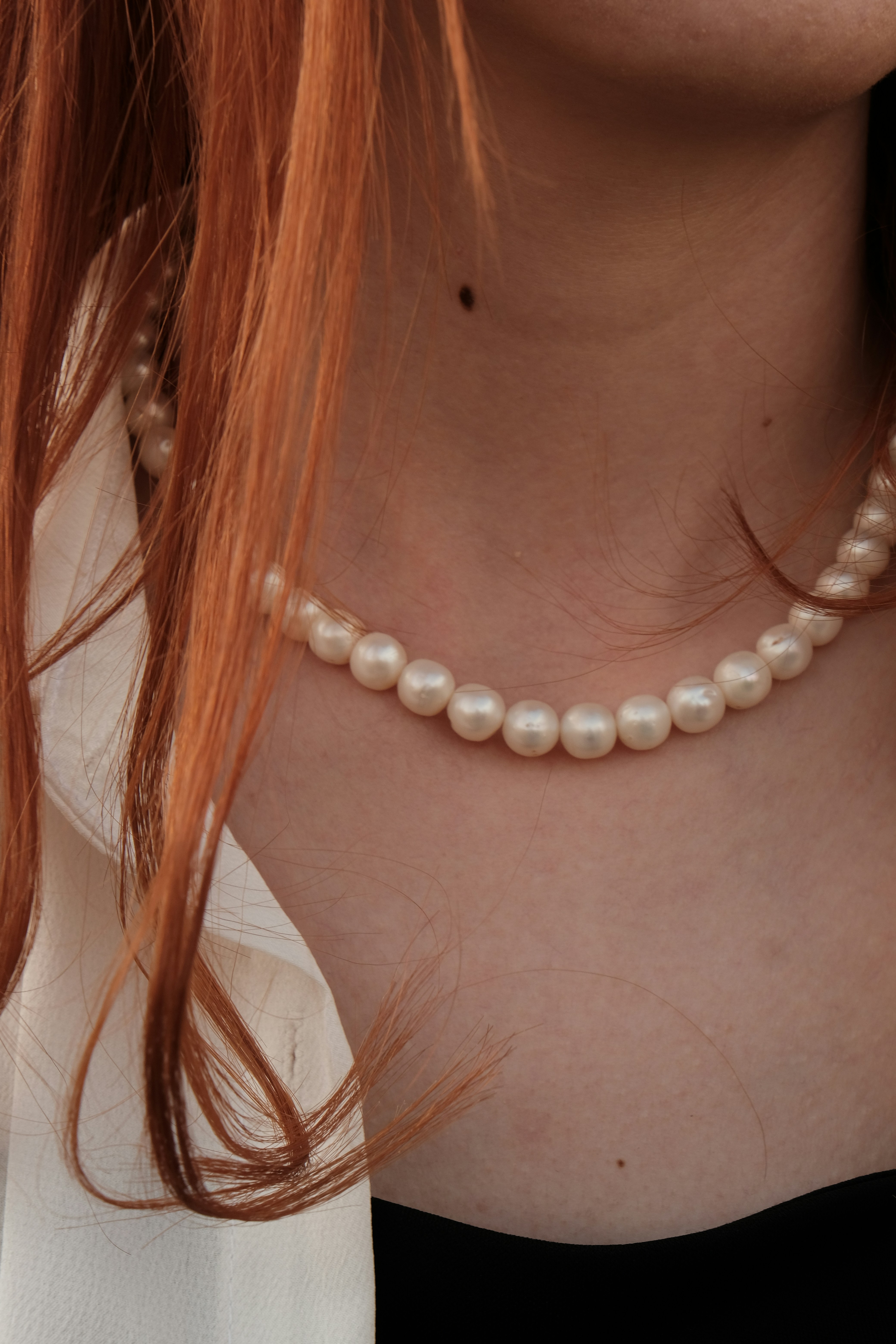 A woman wearing pearls | Source: Unsplash