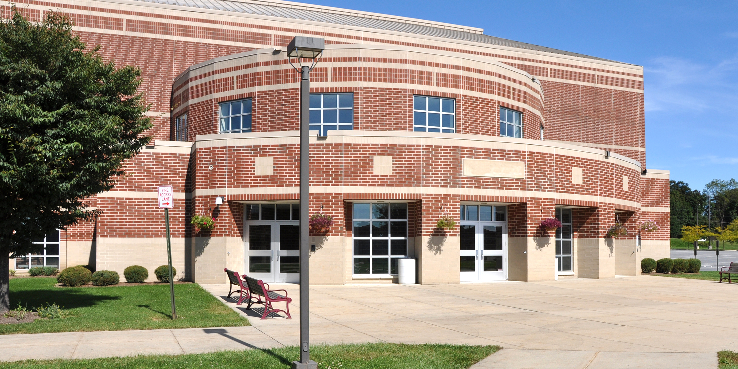 A large school building with brick walls and tall windows | Source: Shutterstock