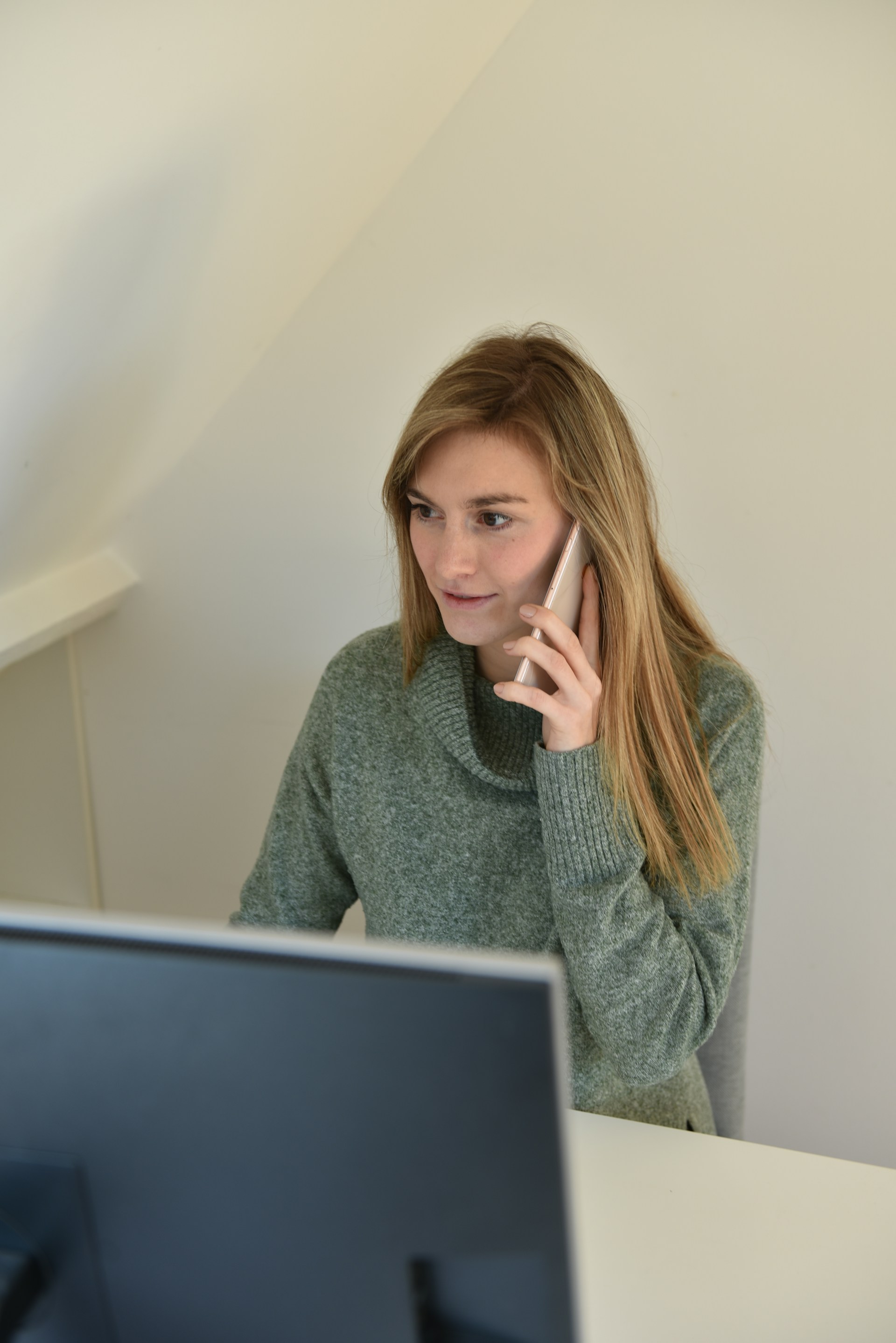 A woman smiling during a phone call | Source: Unsplash