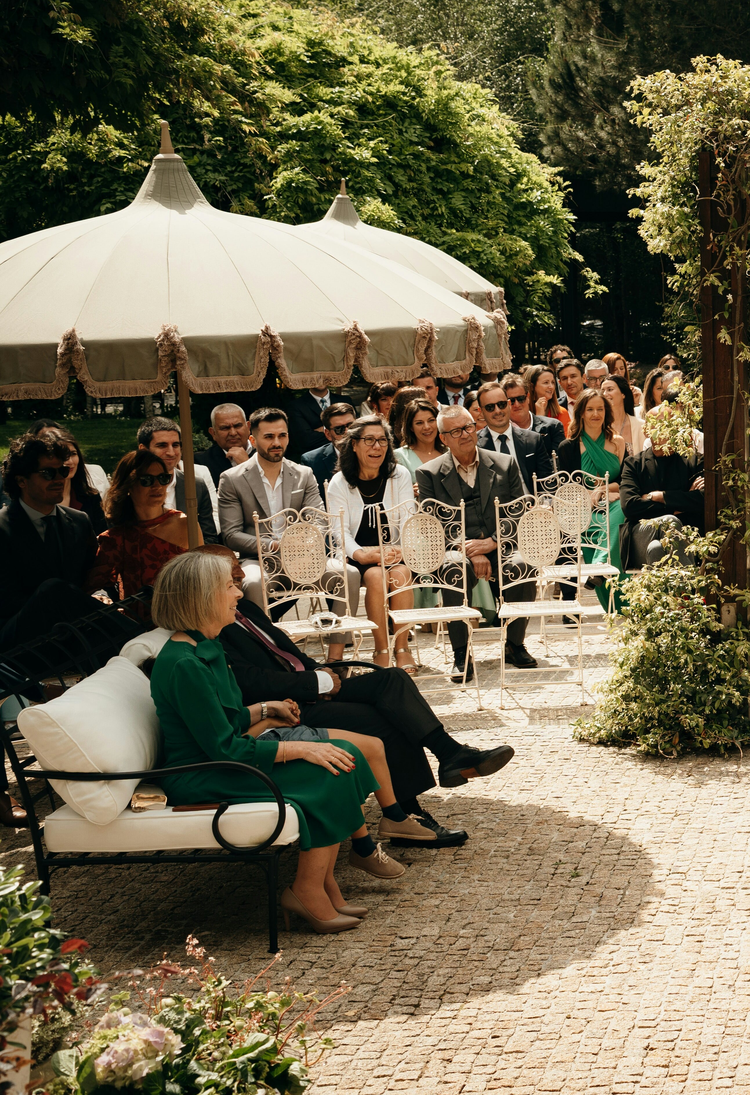 Guests seated at an outdoor wedding ceremony | Source: Unsplash