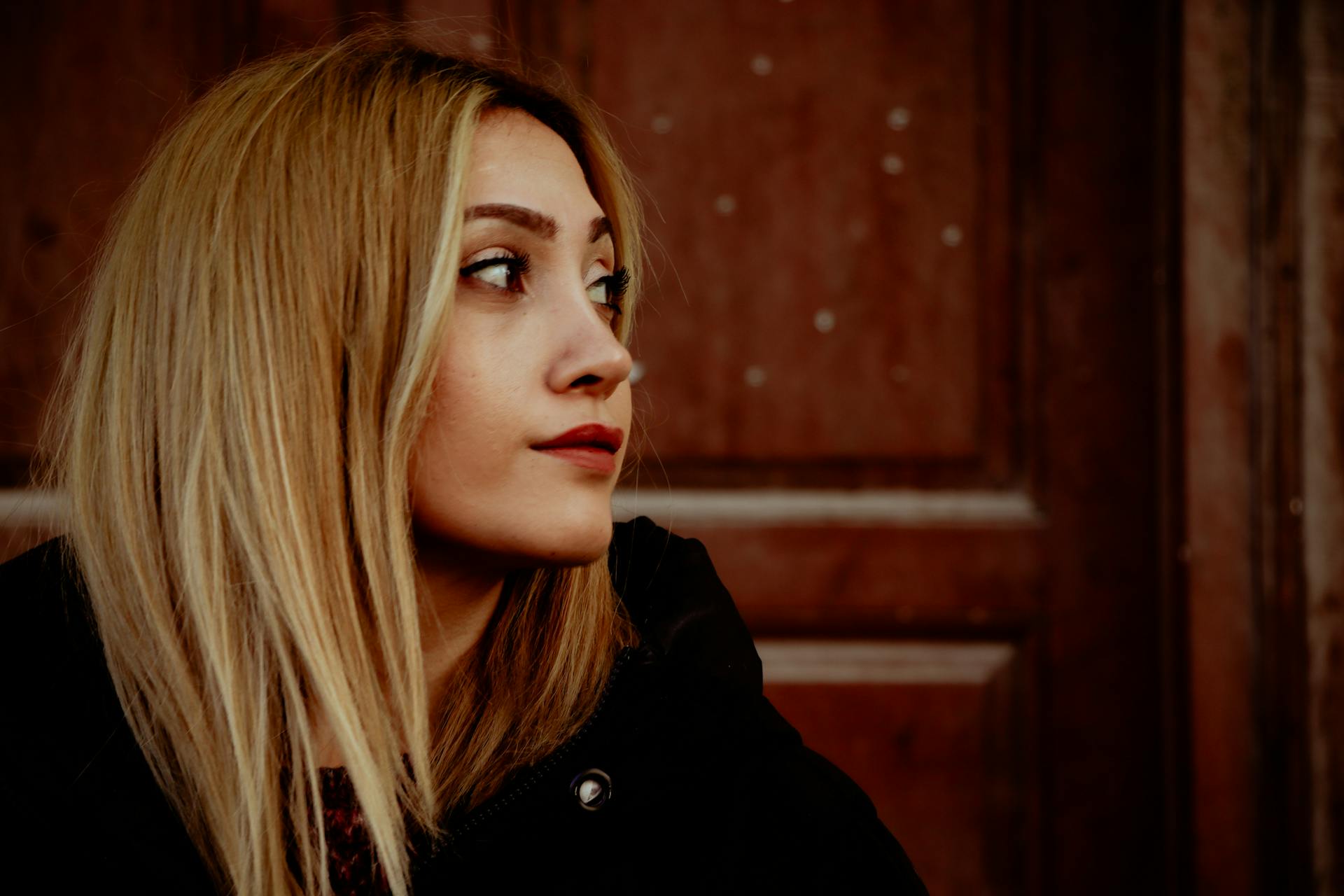 A woman smiling faintly at someone | Source: Pexels