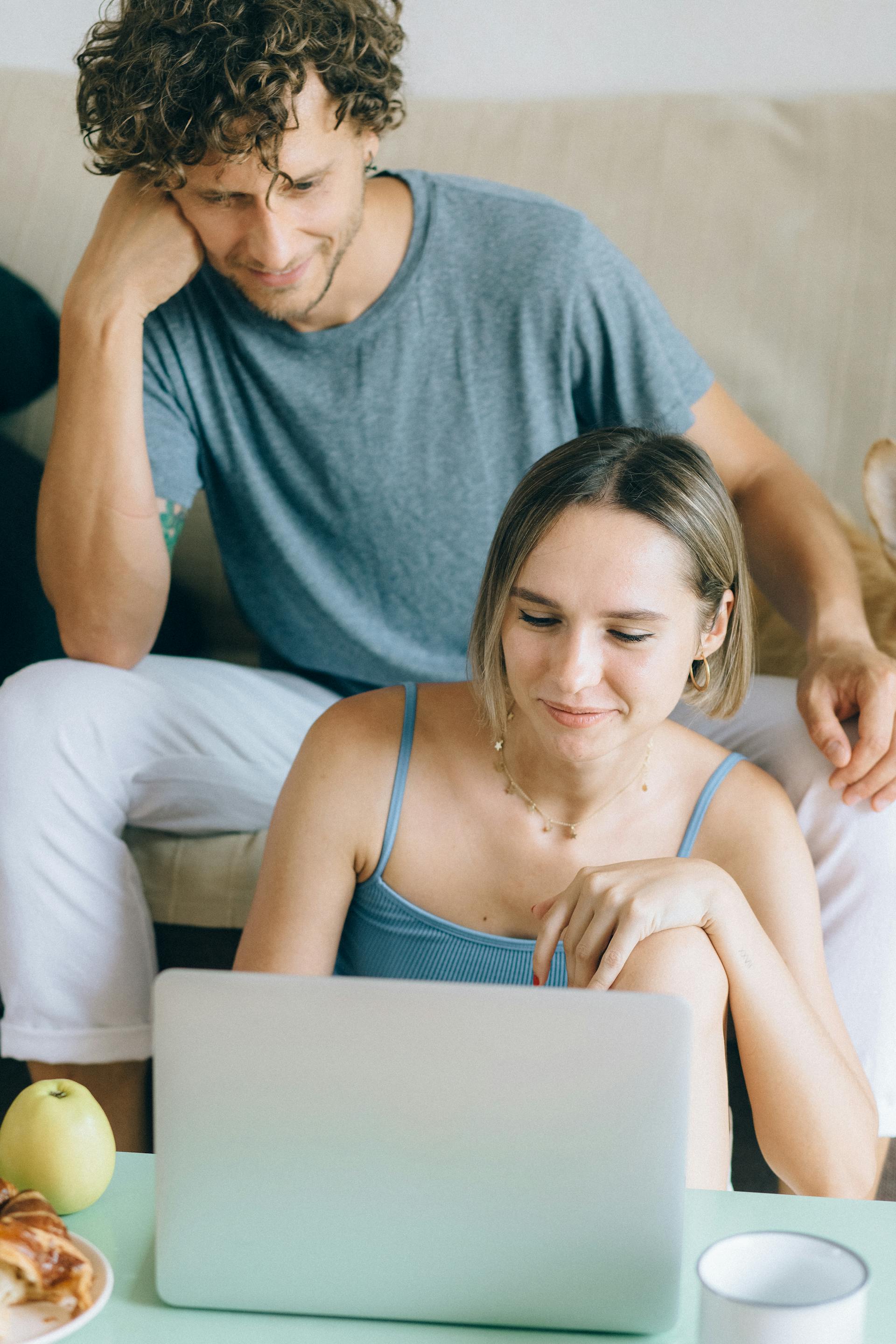 A man and woman looking at a laptop screen together | Source: Pexels