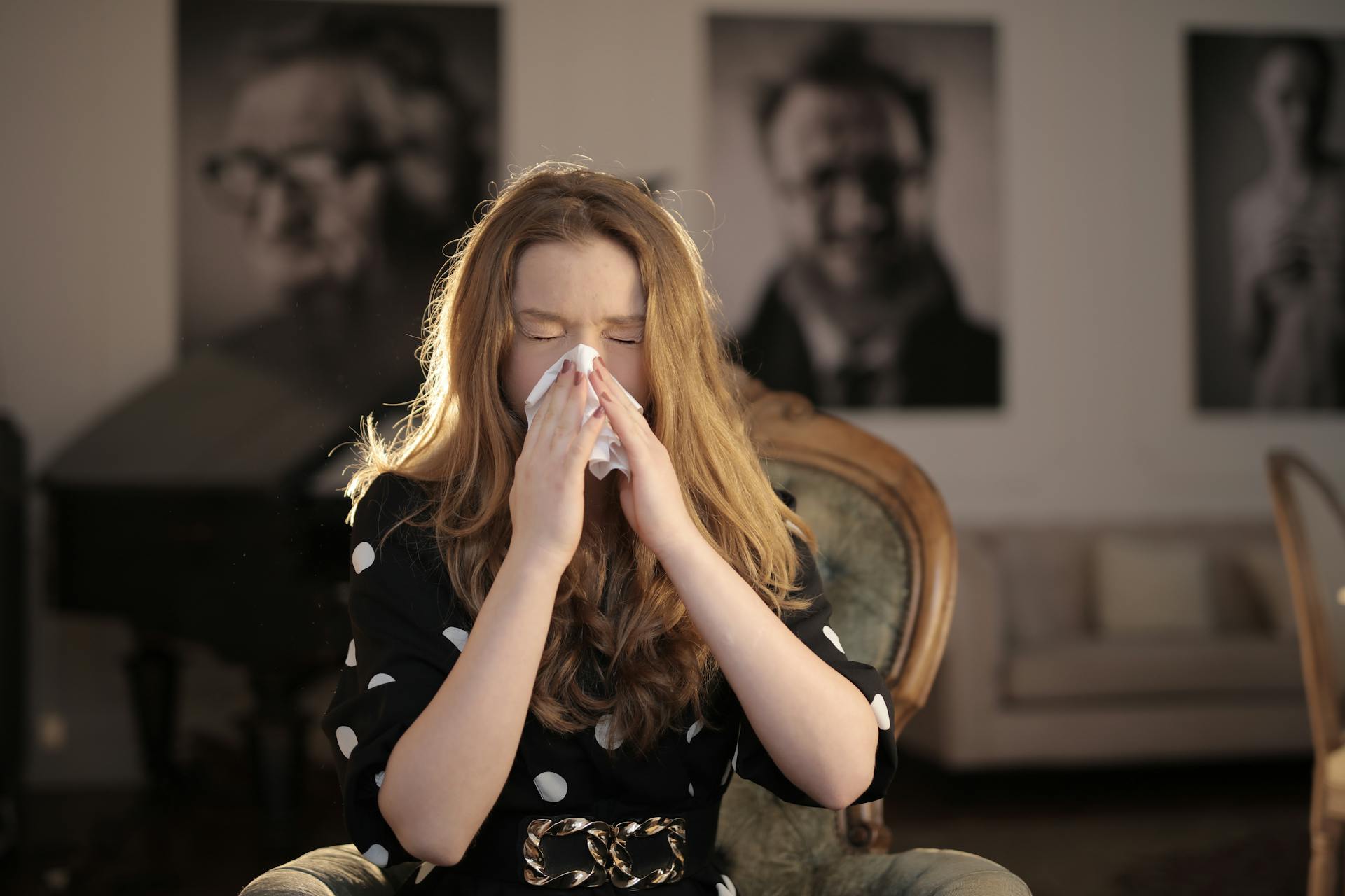 A young woman wiping her nose | Source: Pexels