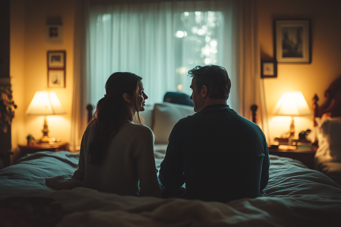 Couple talking in their bedroom | Source: Midjourney