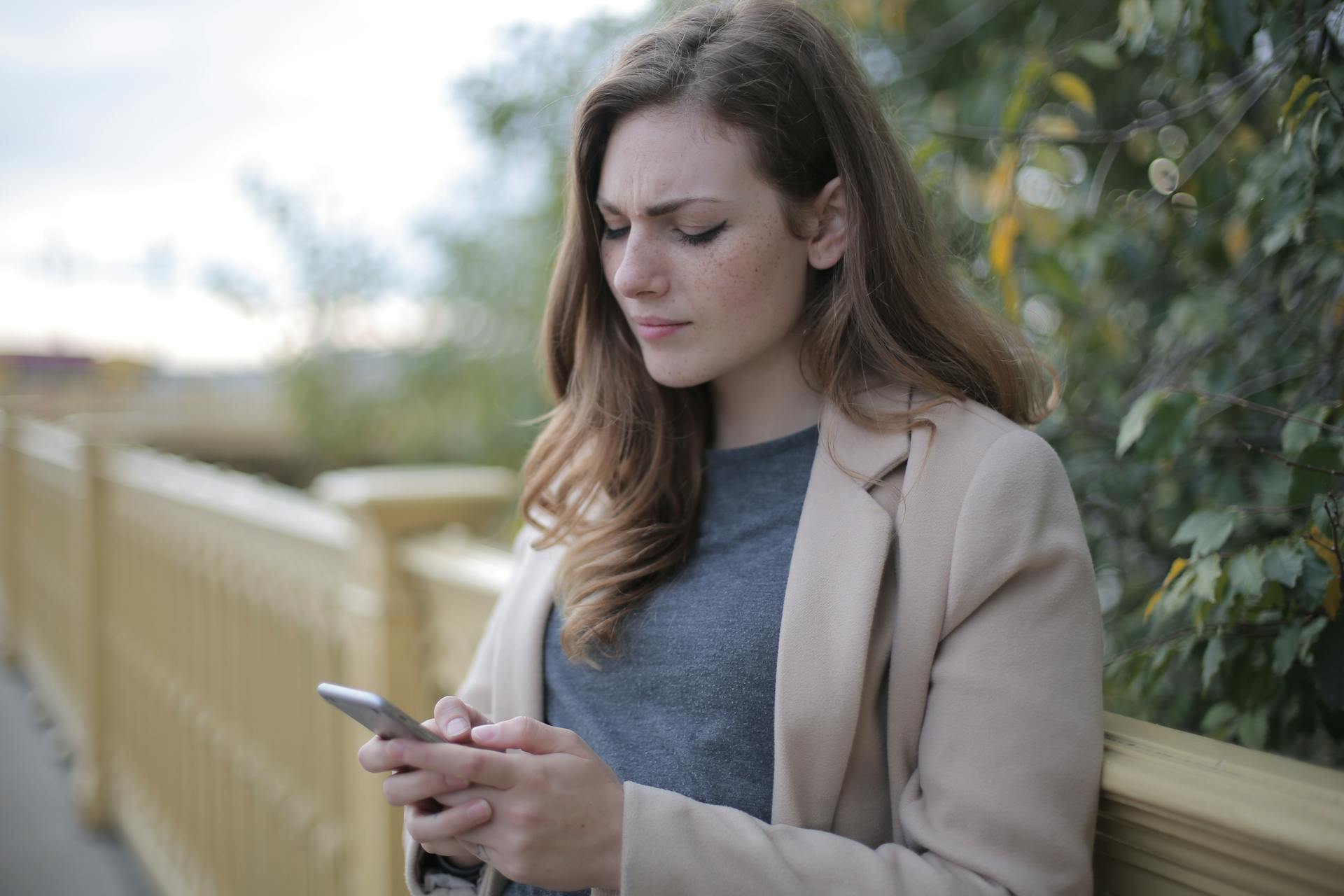 A woman looking at her phone | Source: Pexels