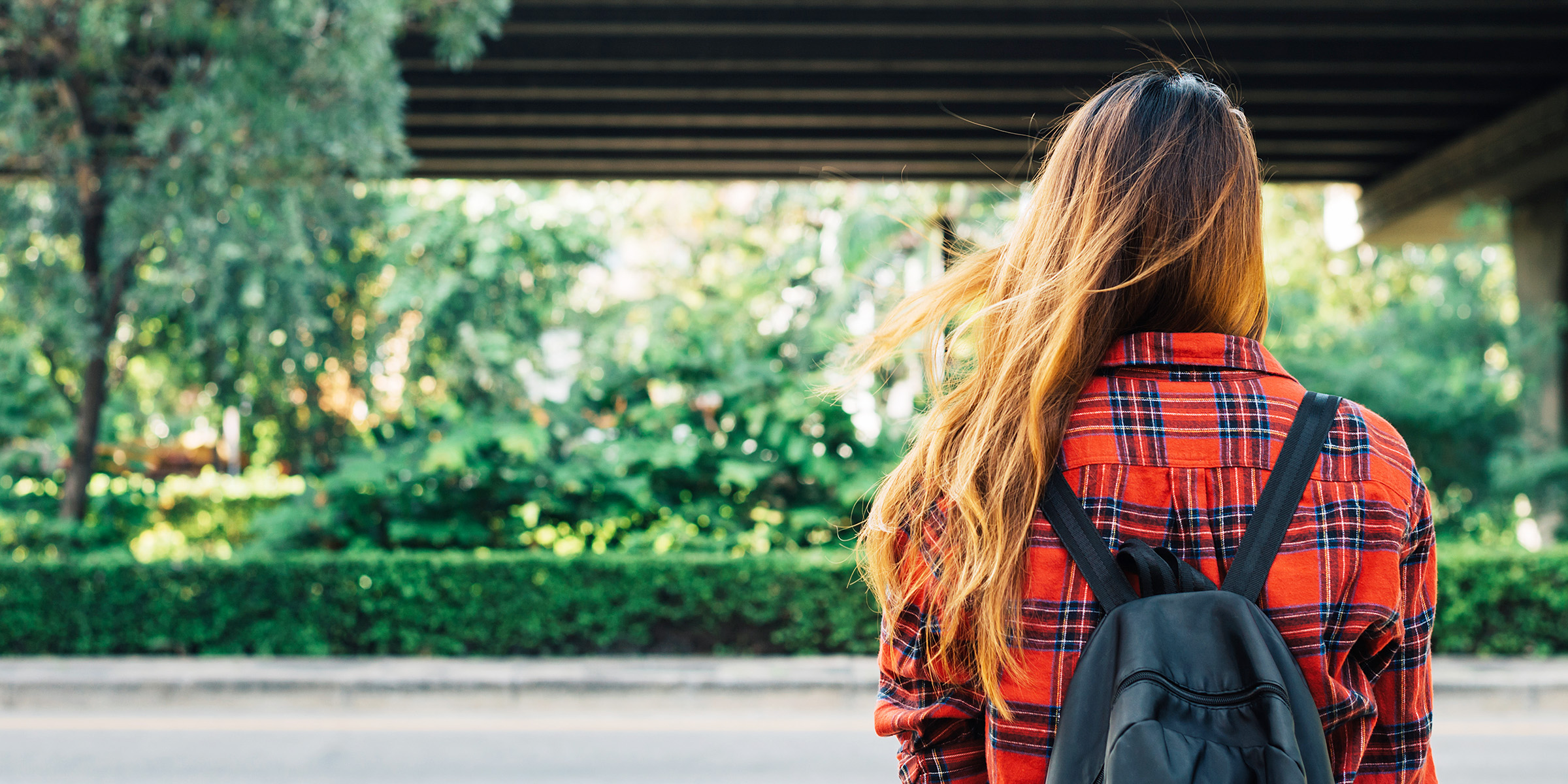 A woman standing with a backpack | Source: Freepik