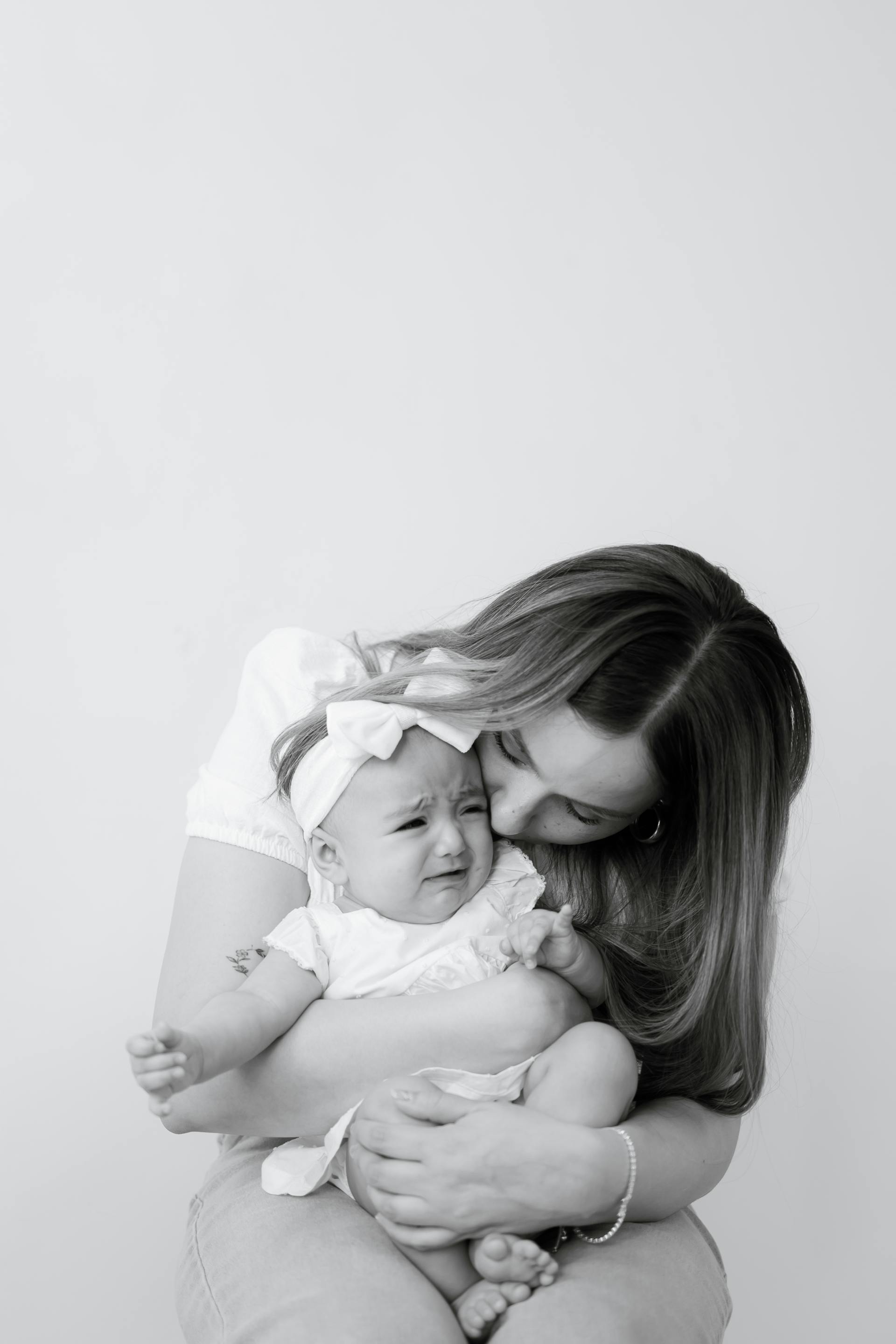 Grayscale of a woman holding a baby | Source: Pexels