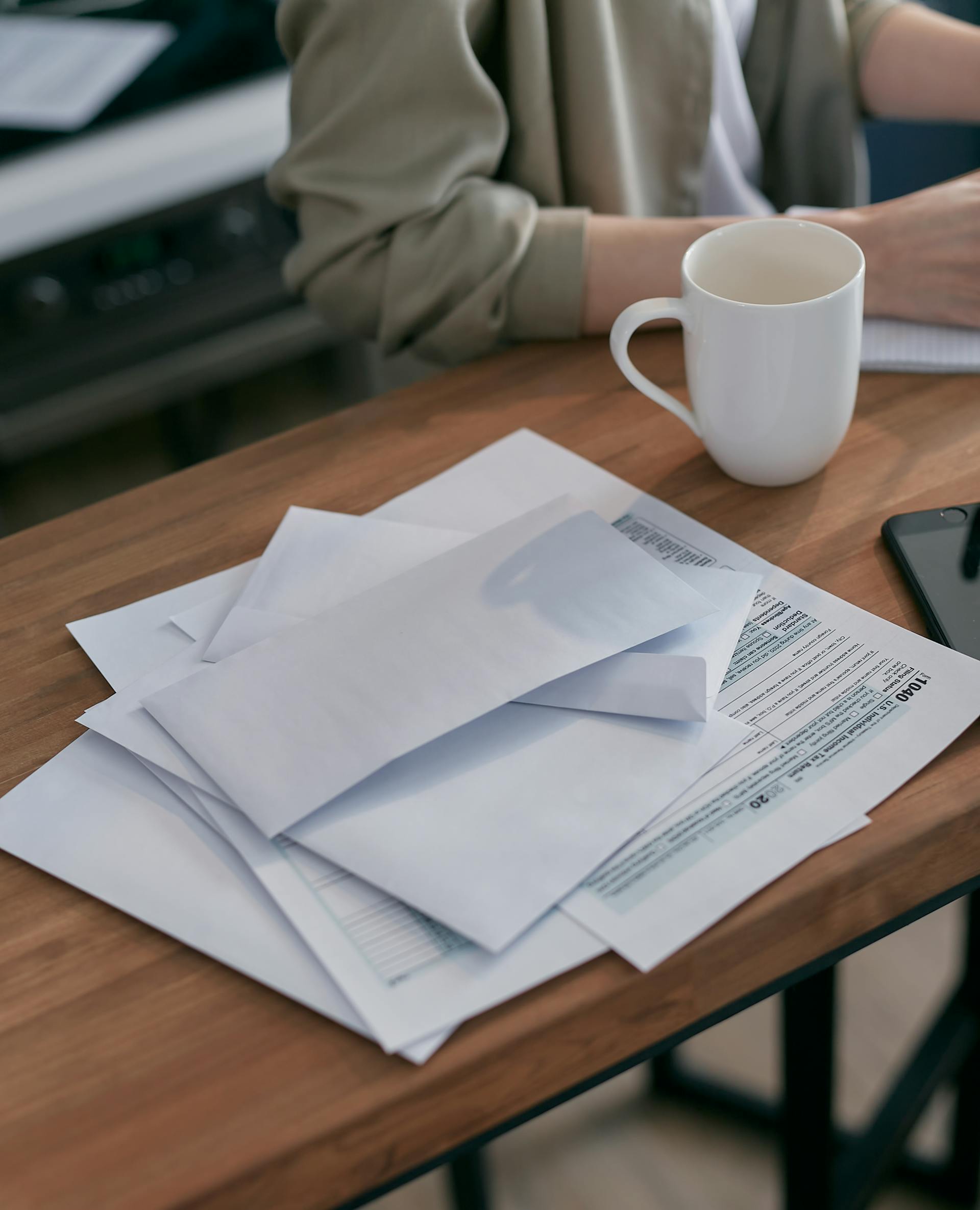 White envelopes and documents lying on a table | Source: Pexels