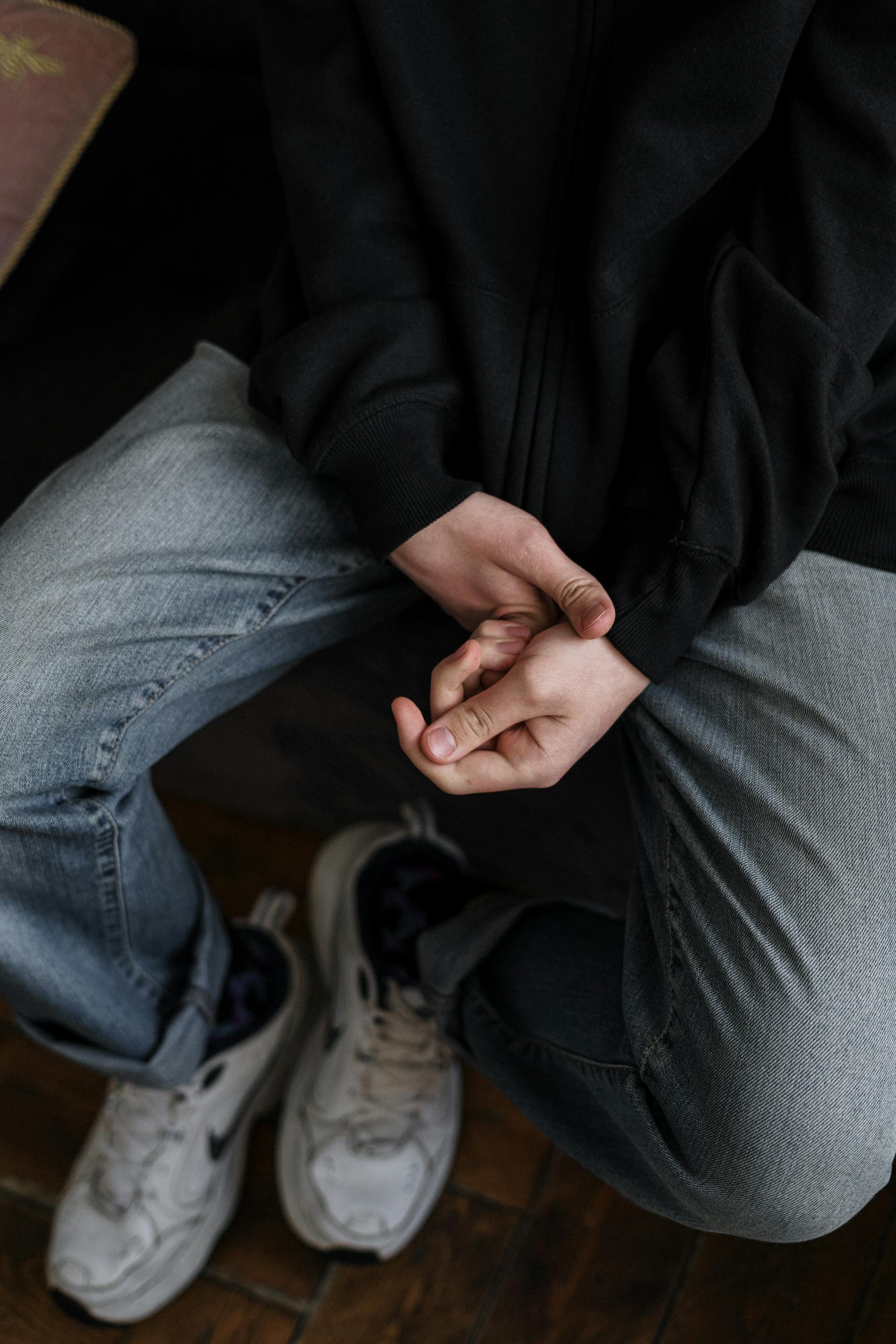 A close-up shot of a person in a black jacket and denim jeans | Source: Pexels