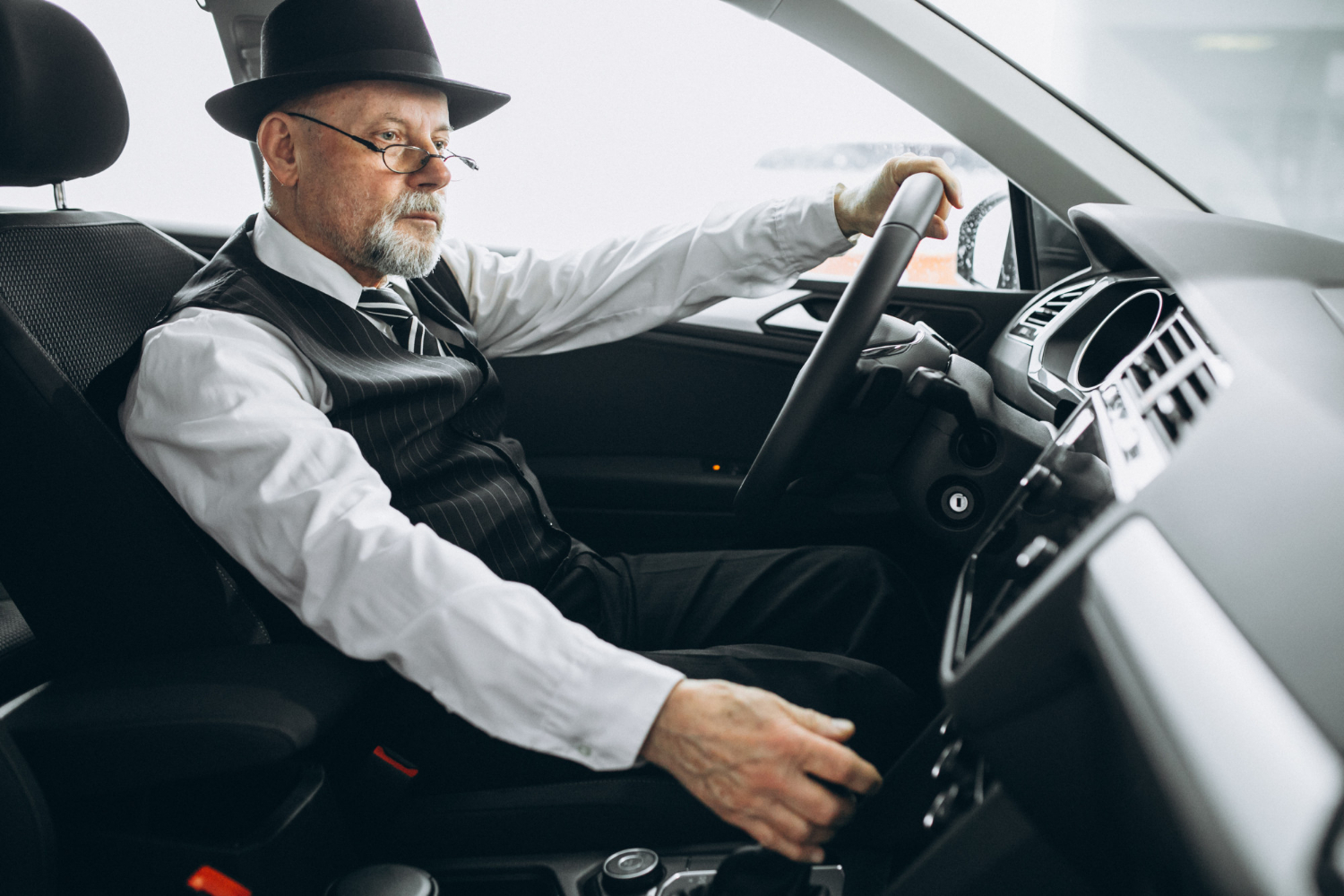 A wealthy senior man driving his car | Source: Freepik