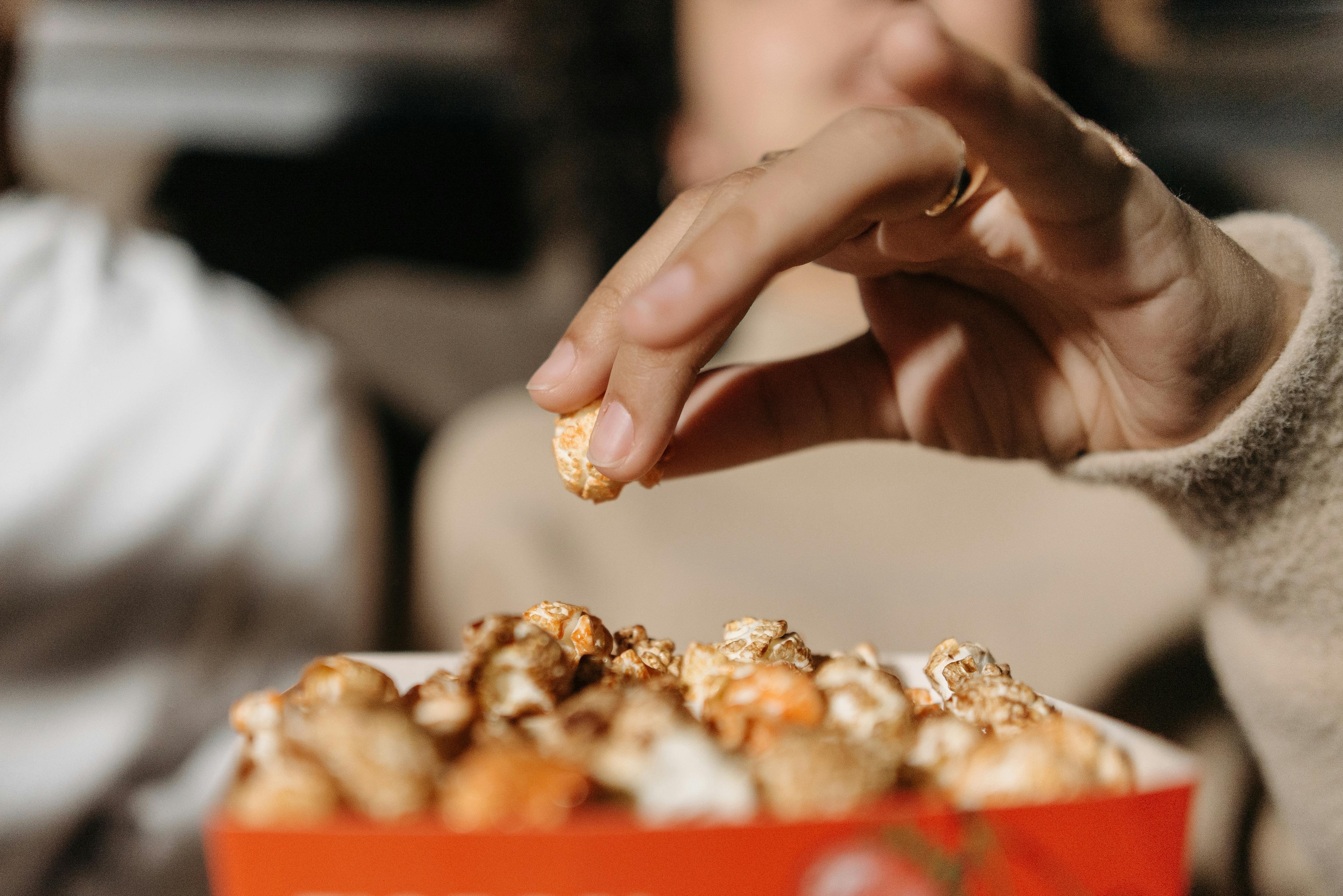 A woman eating popcorn | Source: Pexels