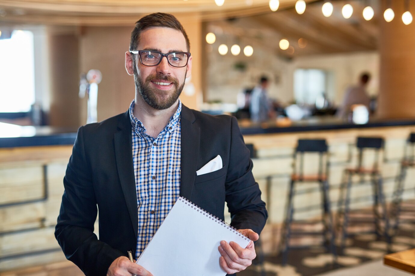 A restaurant manager with a notepad | Source: Pexels