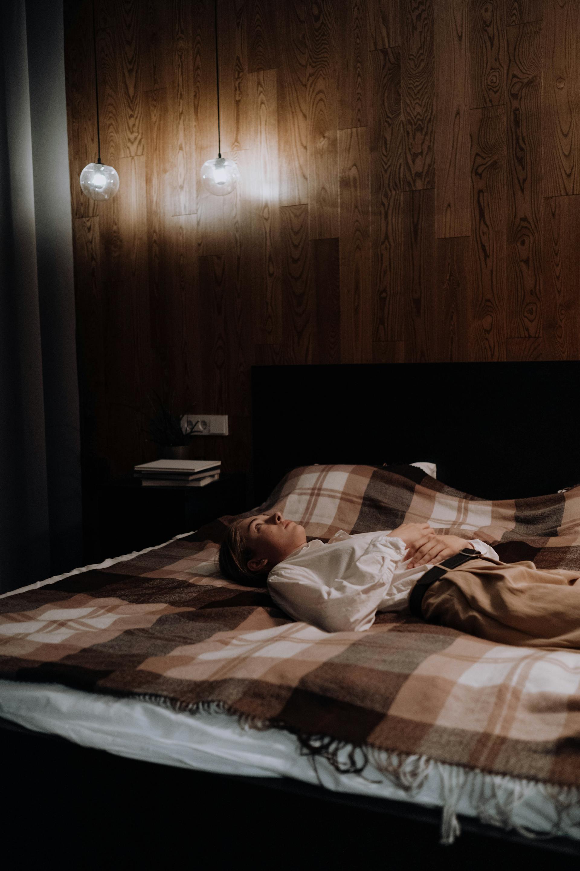 A woman lying awake at night | Source: Pexels