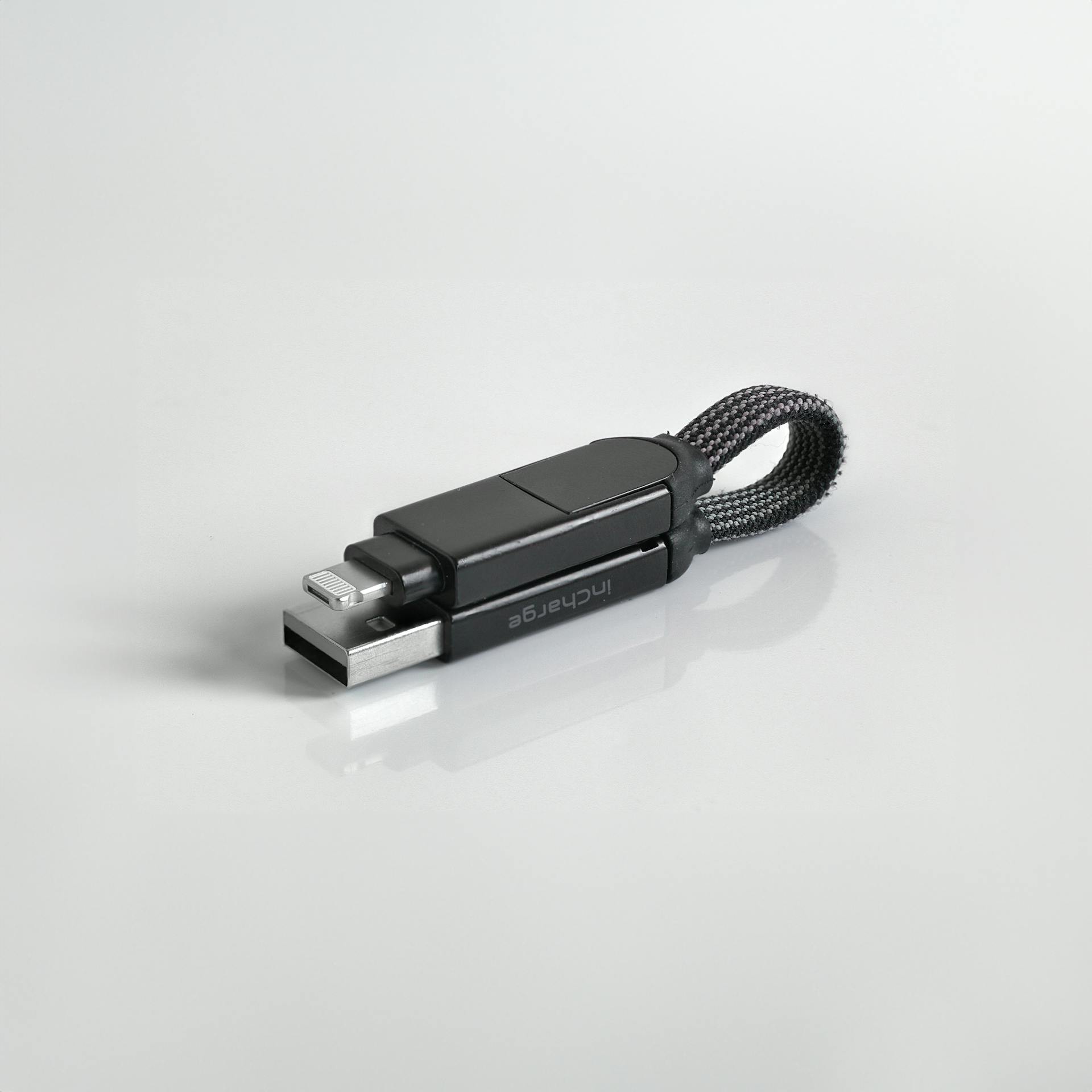 A flash drive lying on a white surface | Source: Pexels