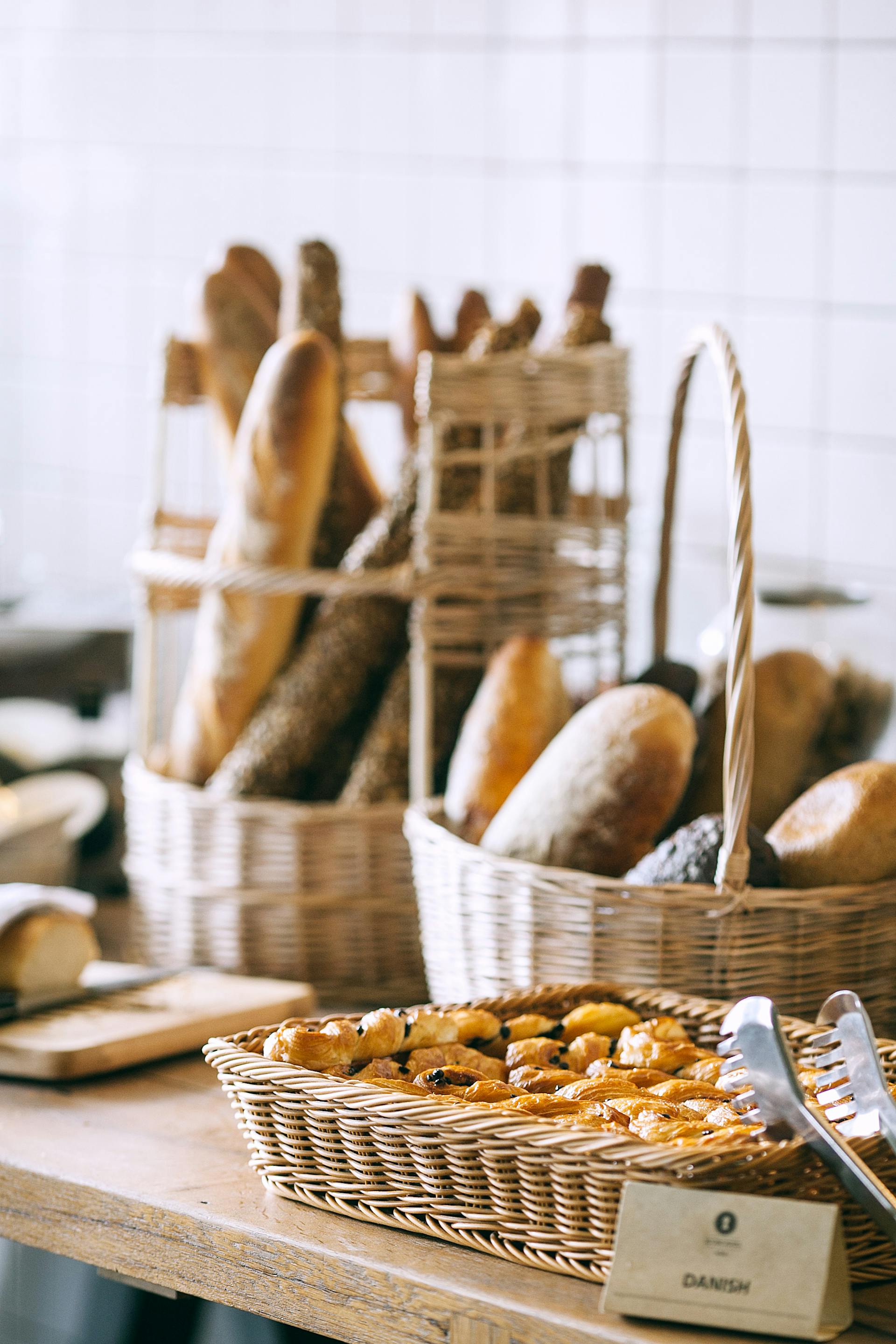 A collection of baked bread and buns in a bakery shop | Source: Pexels