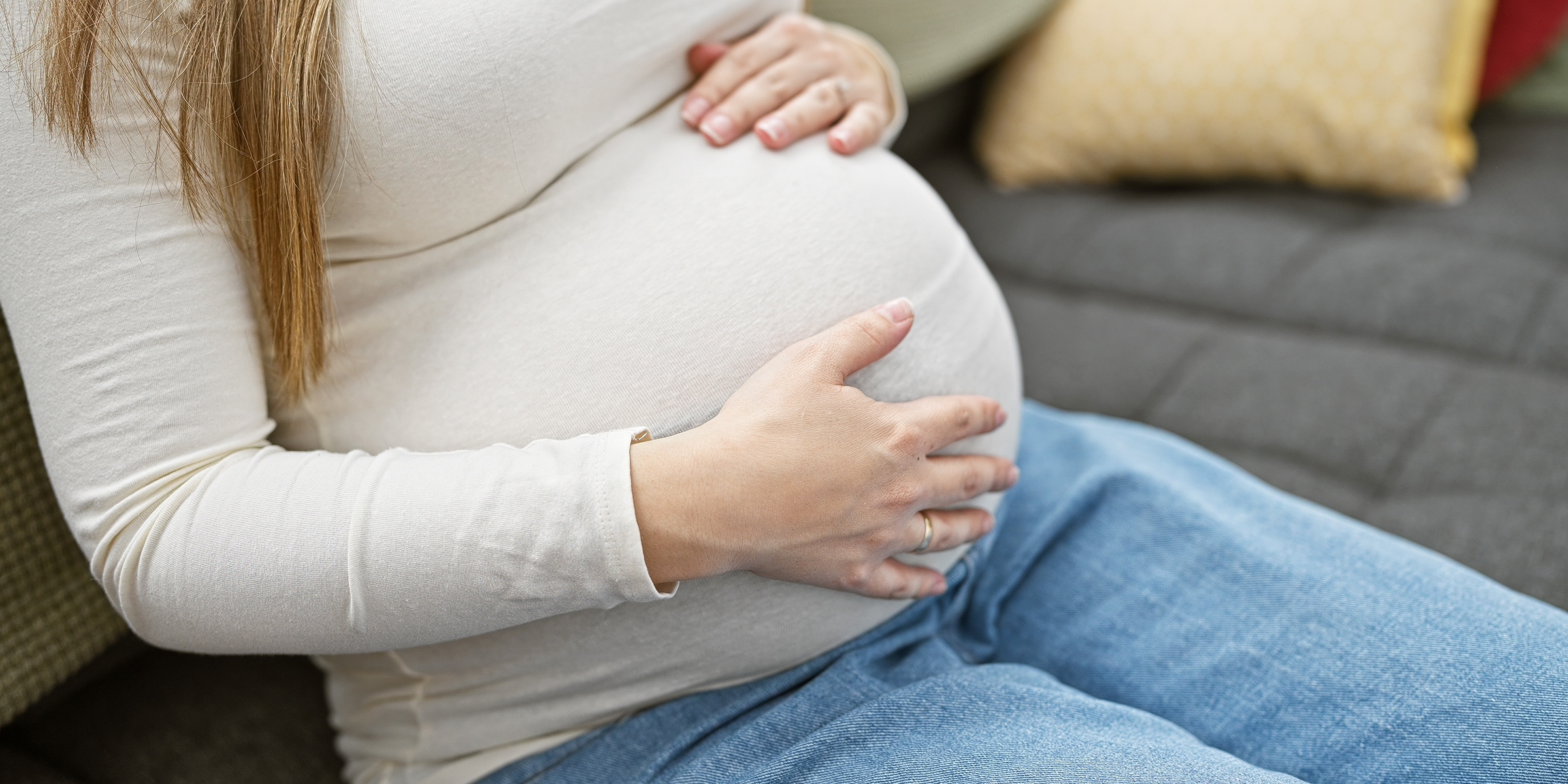 A pregnant woman holding her belly | Source: Shutterstock