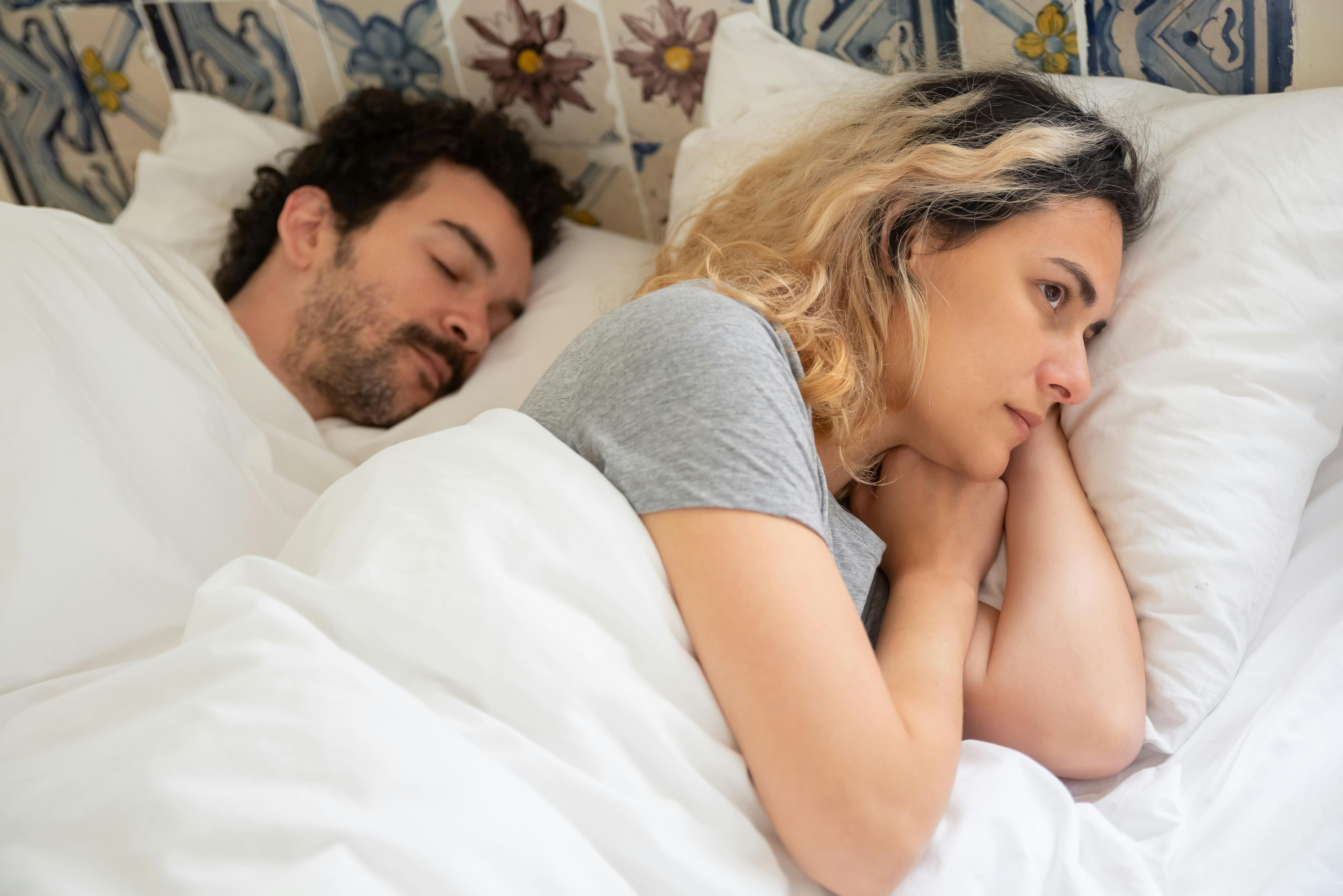 A woman lying awake in bed | Source: Pexels