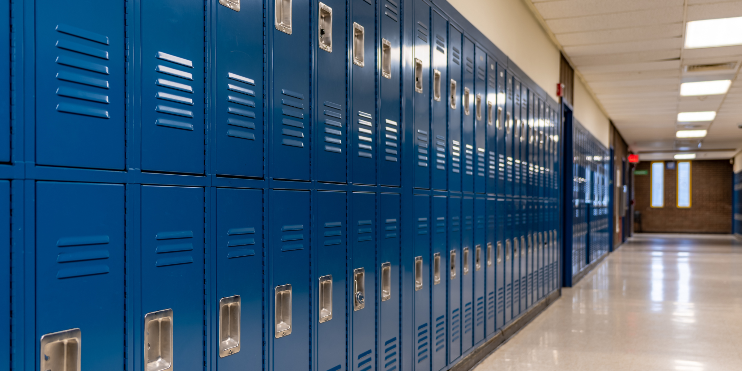 School hallway with blue lockers | Source: Shutterstock