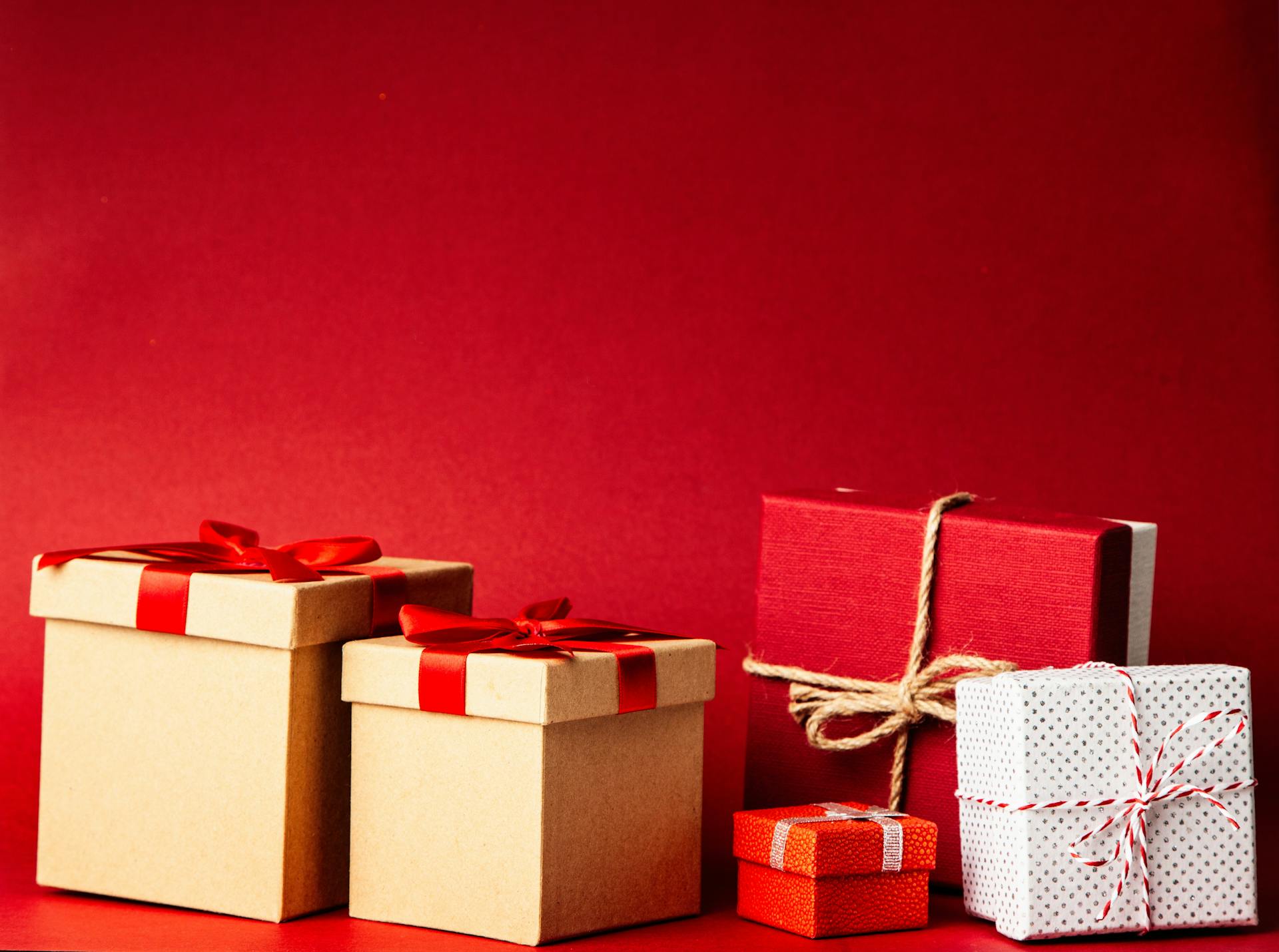 A collection of gift boxes against a red background | Source: Pexels