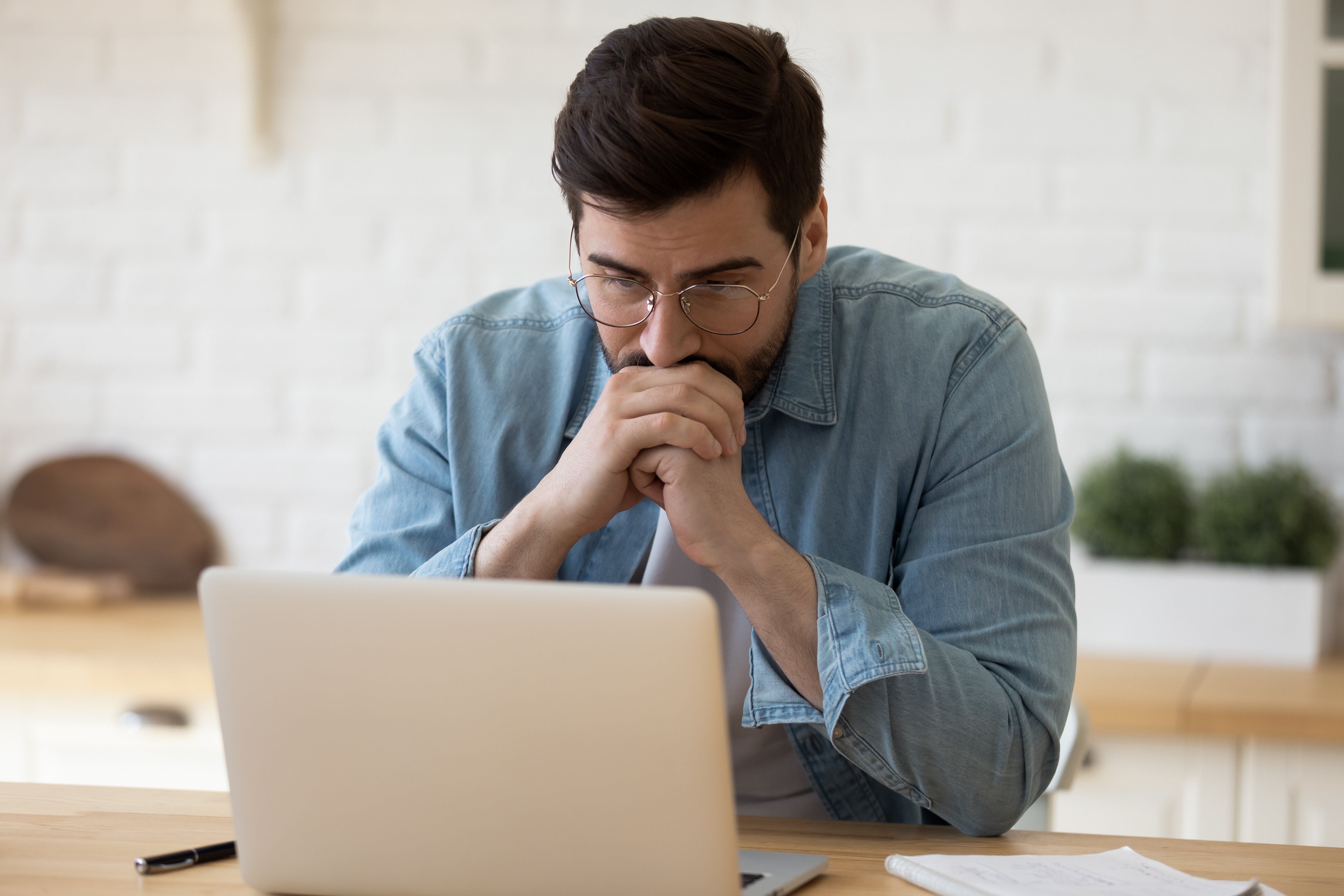 A man staring at his computer | Source: Shutterstock