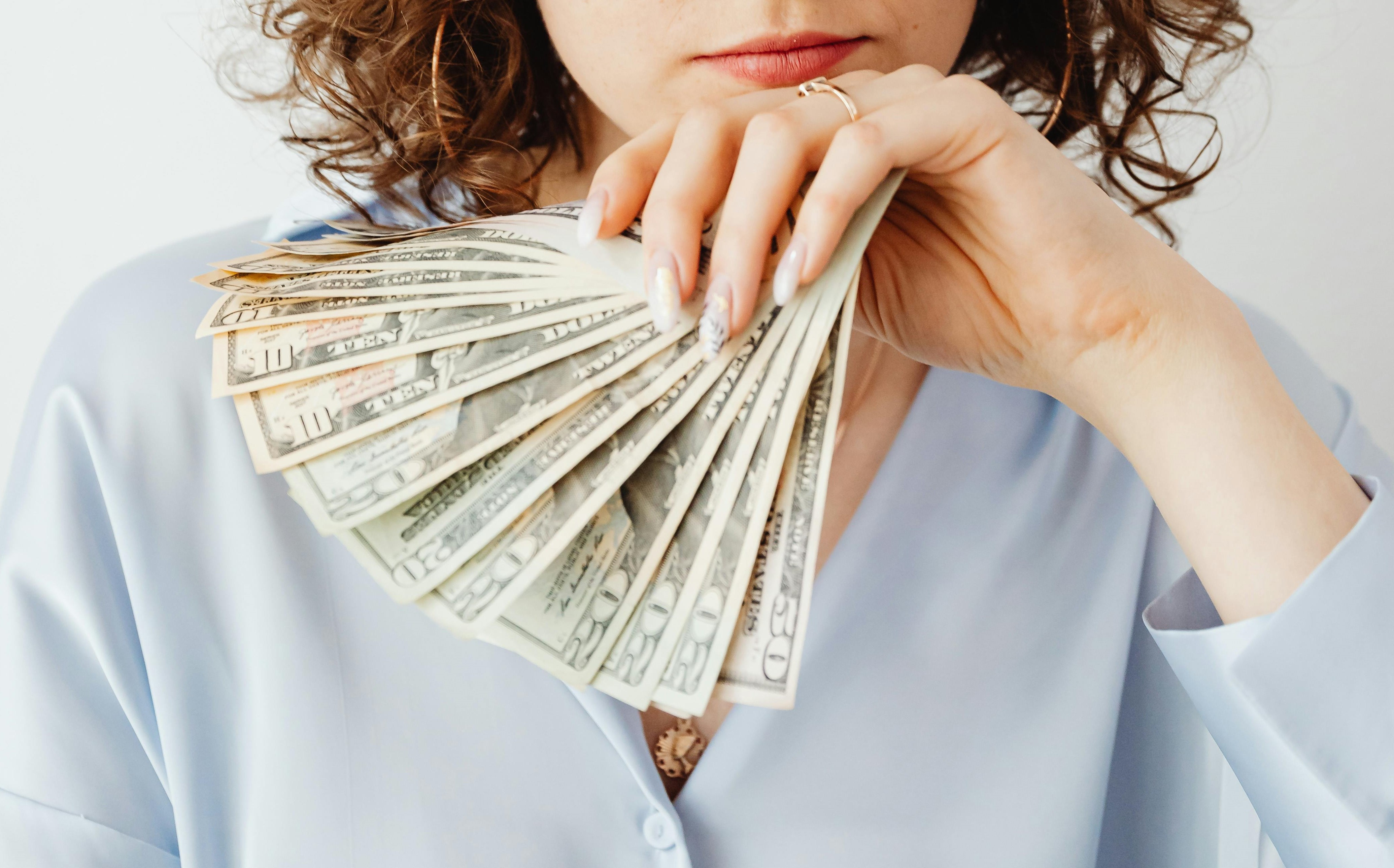 A woman holding money | Source: Pexels