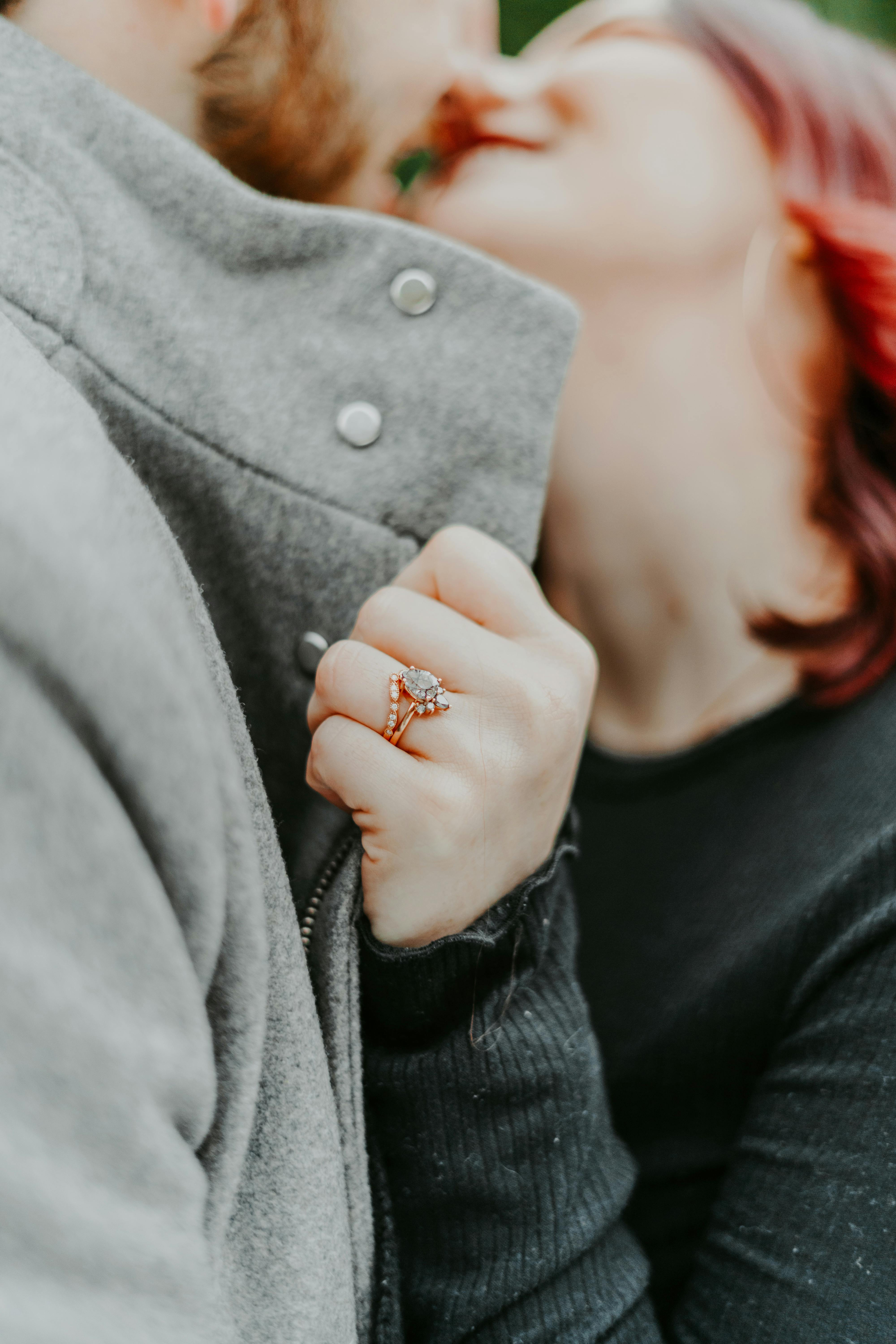 Engaged couple kissing | Source: Midjourney