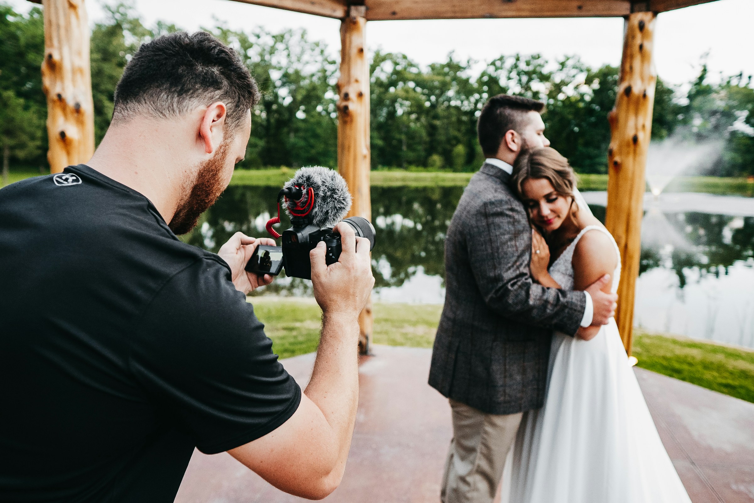 A man clicking a picture of a bride and groom | Source: Unsplash