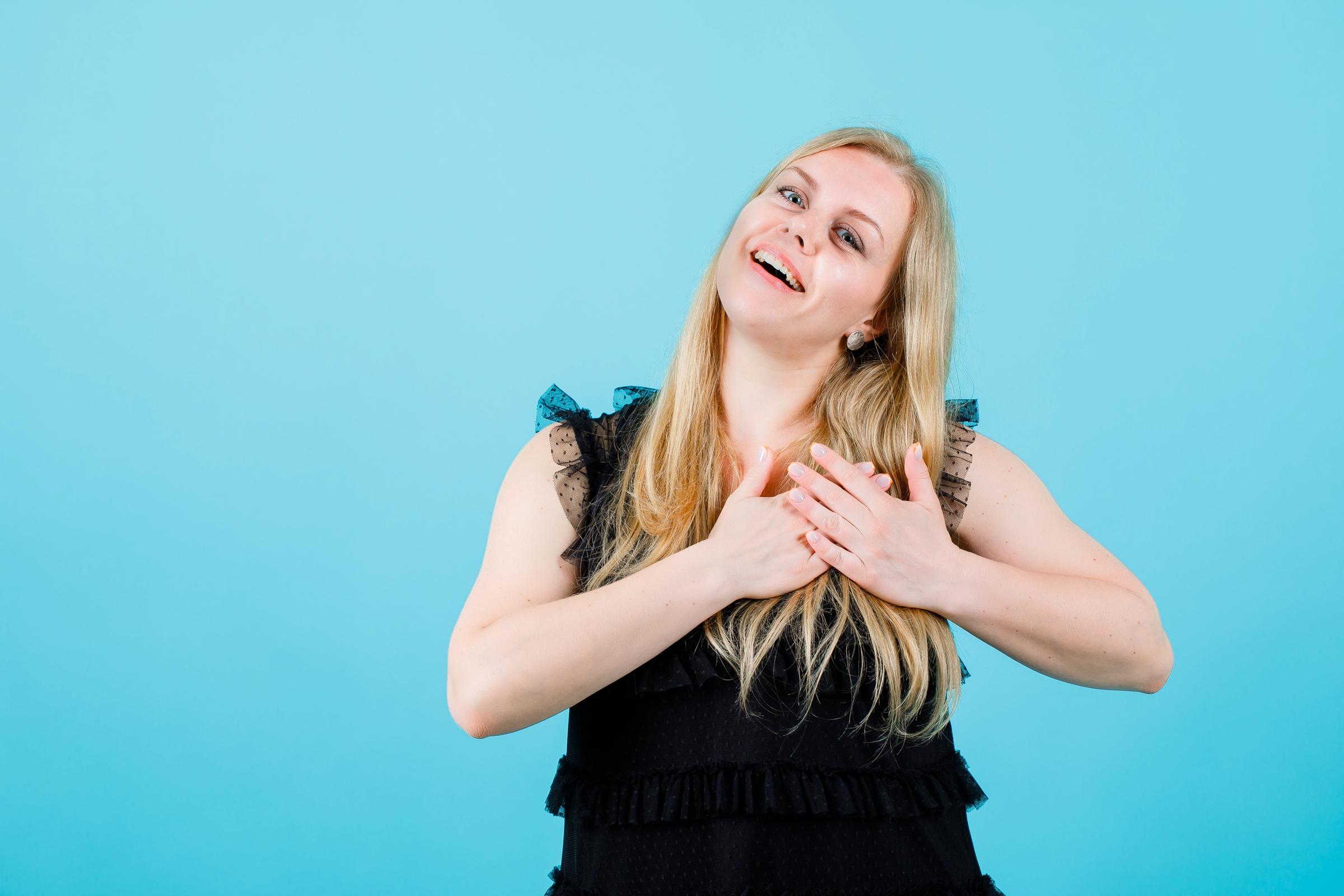 A woman making a vow with her hands over her heart | Source: Freepik