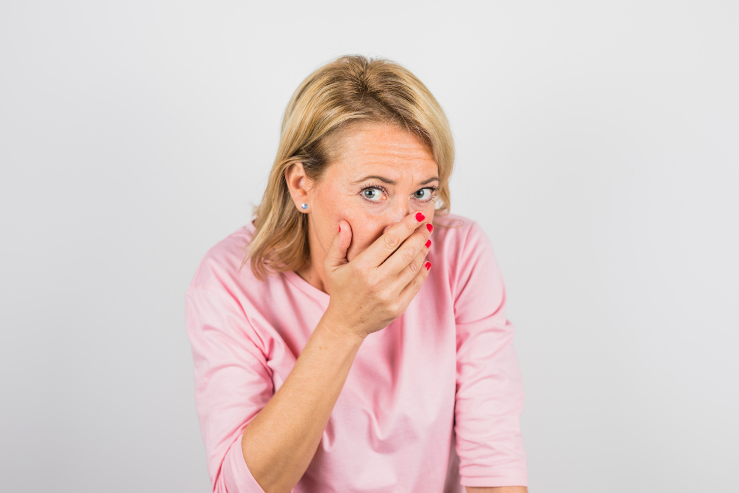 A stunned and embarrassed senior woman | Source: Freepik