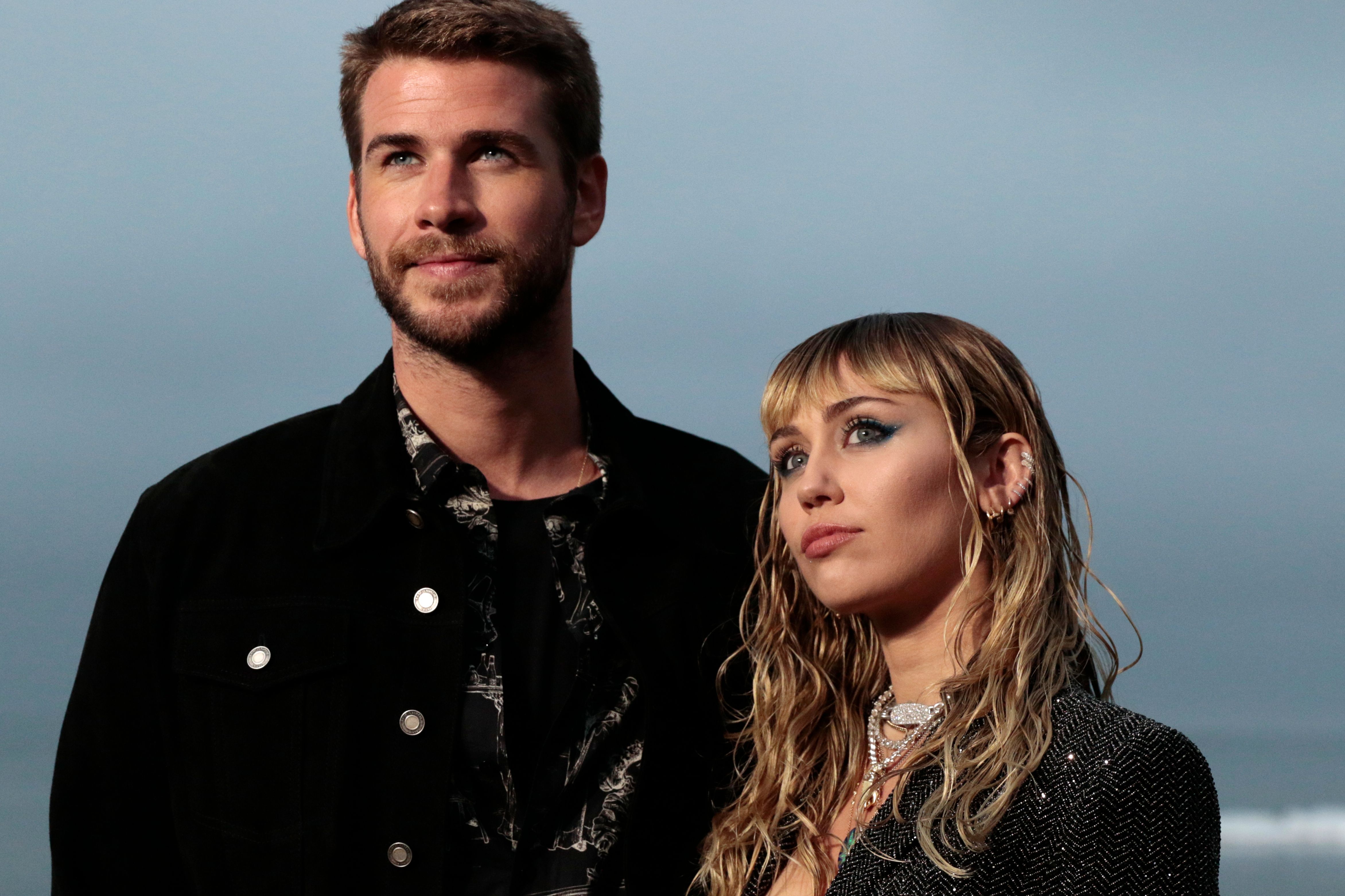 Miley Cyrus and Liam Hemsworth arrive for the Saint Laurent Men's Spring-Summer 2020 runway show in Malibu, California, on June 6, 2019. | Source: Getty Images
