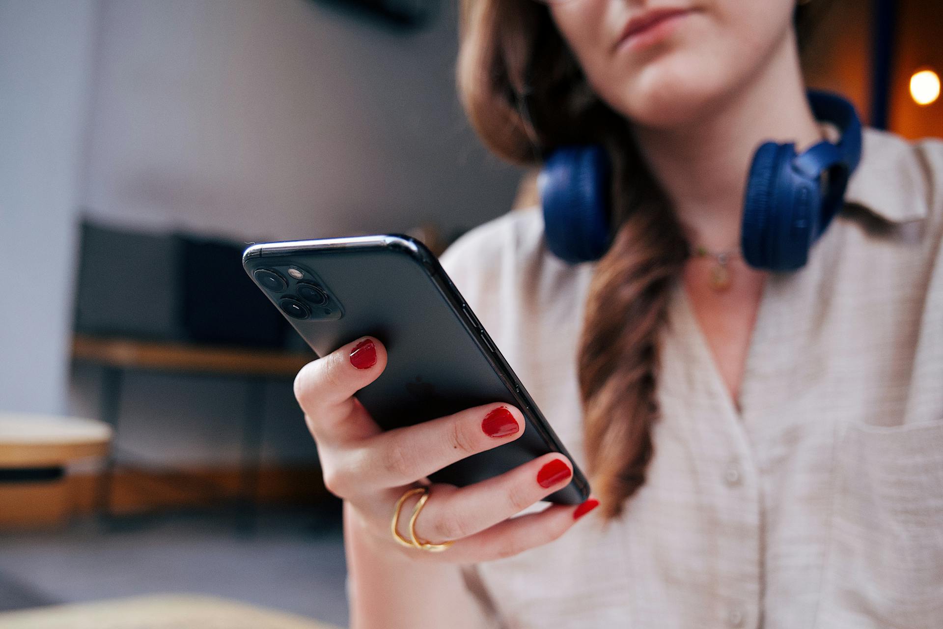 A smiling woman looking at her phone | Source: Pexels