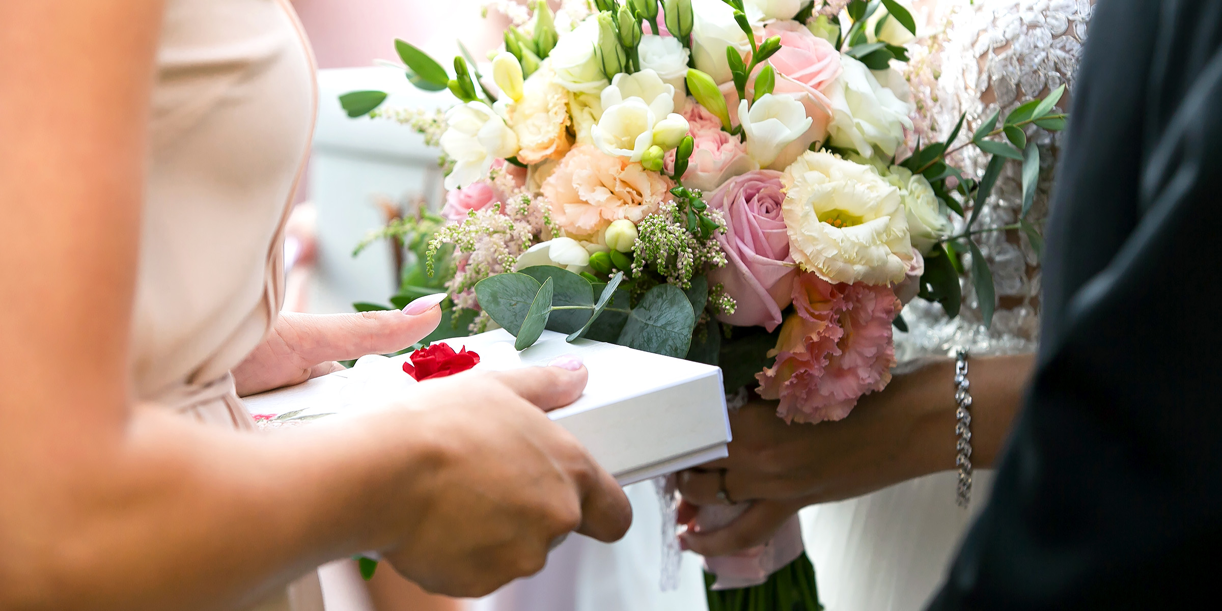 A person giving a bride a gift | Source: Shutterstock