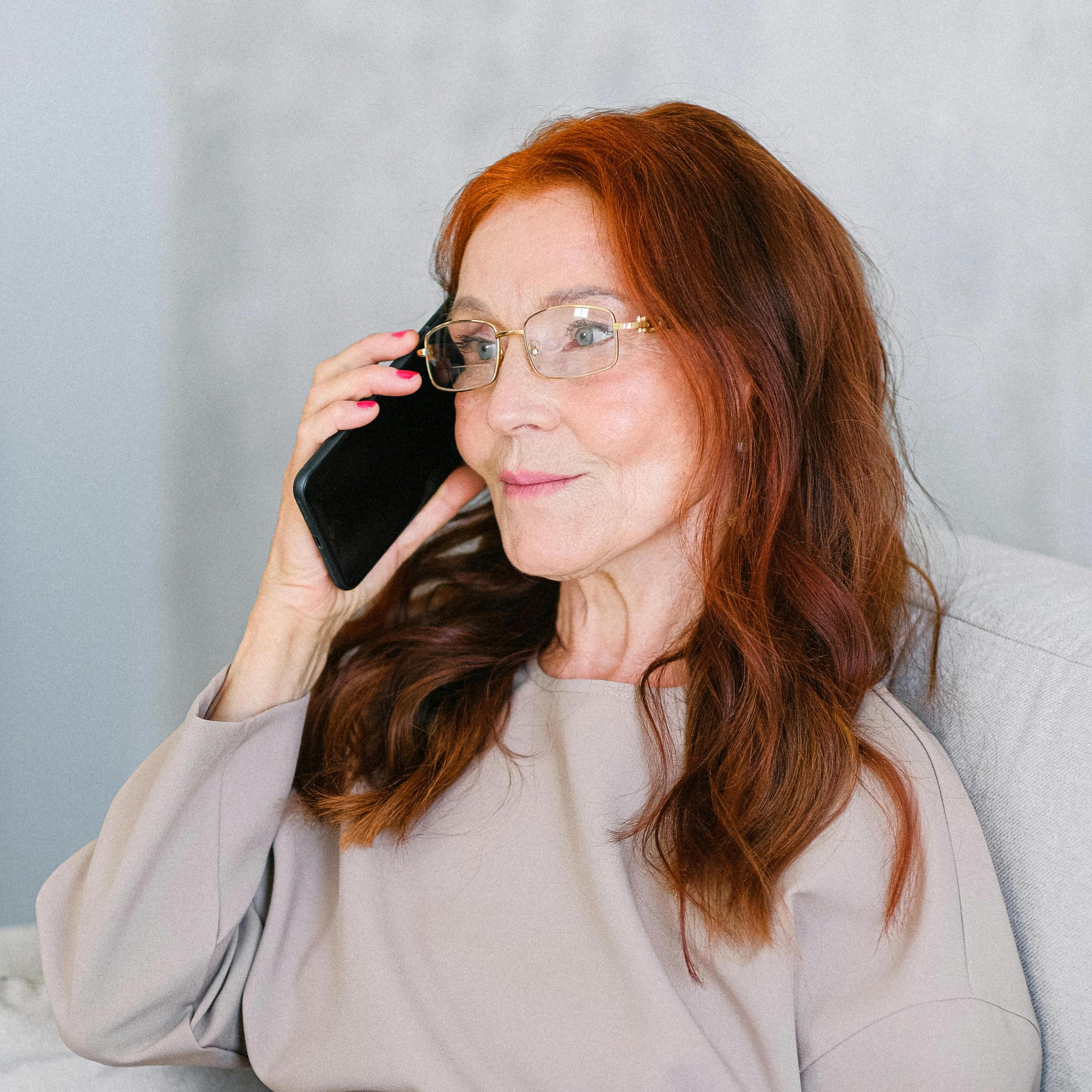 An elderly woman making a phone call | Source: Pexels