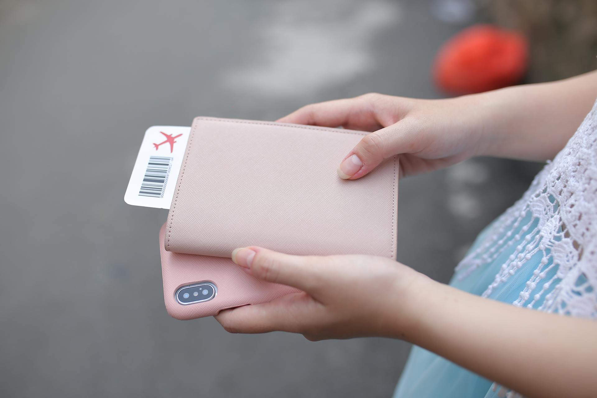 A woman holding a ticket and a phone | Source: Pexels