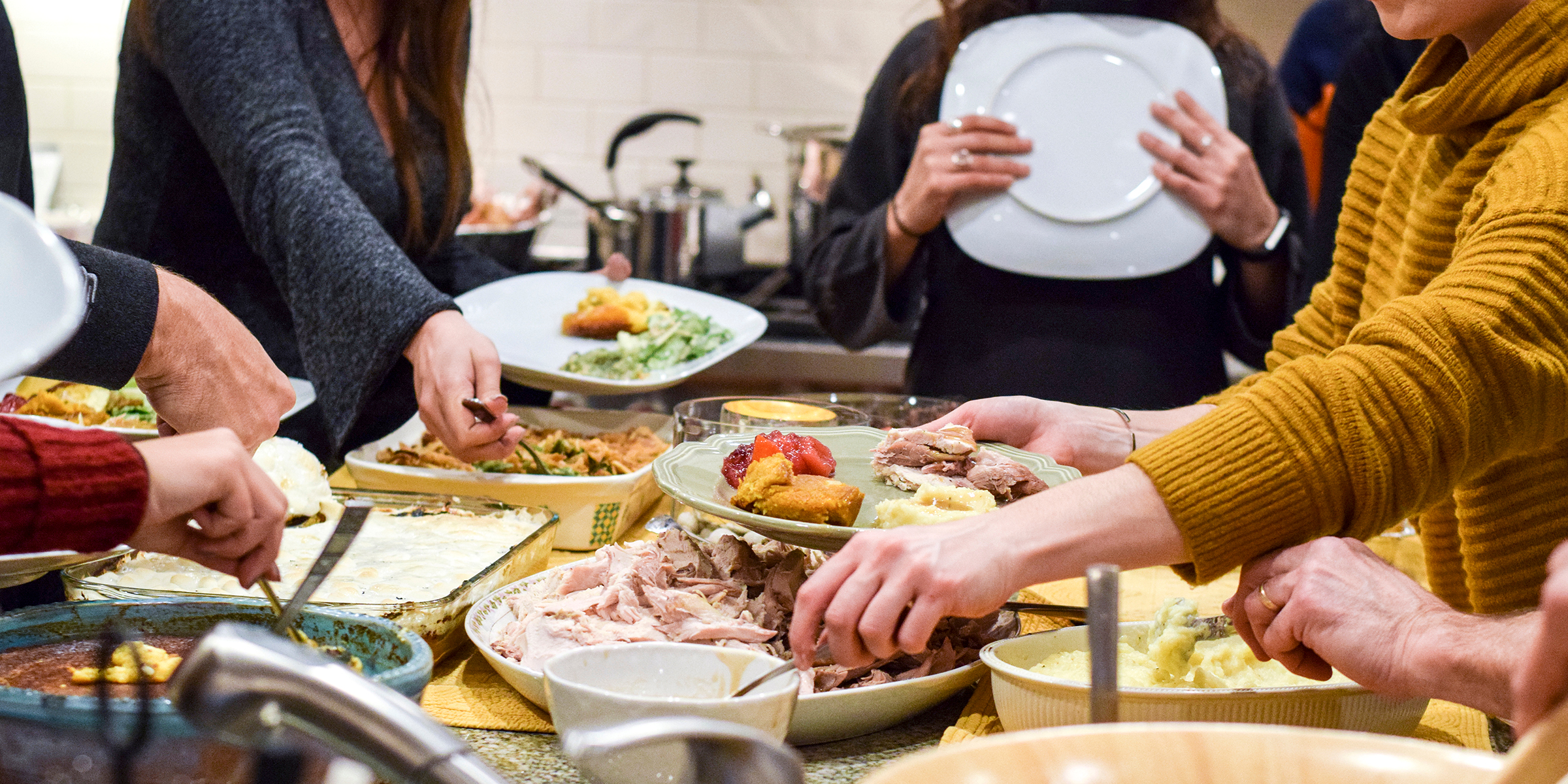 People standing around food | Source: Shutterstock