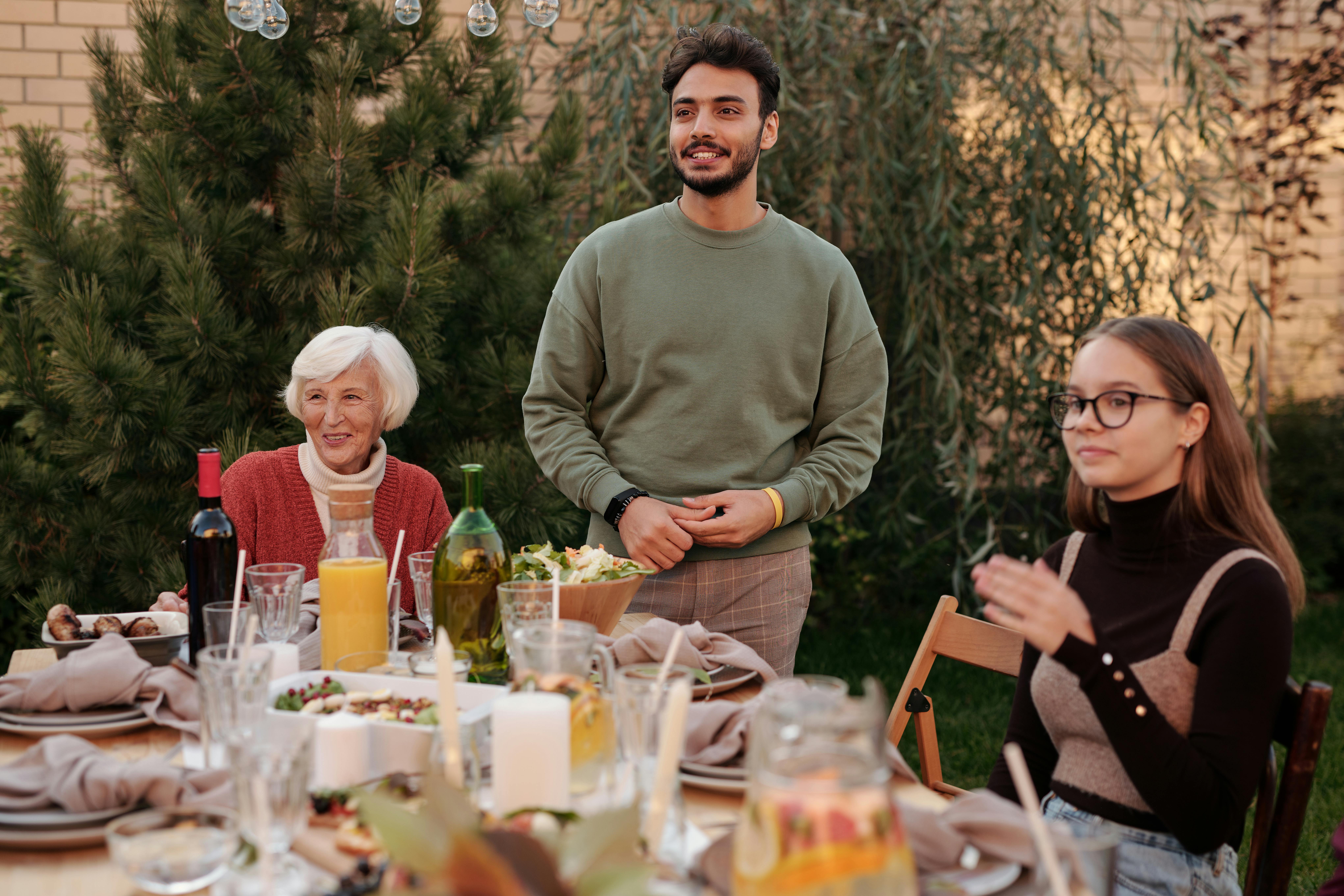A family sitting at a table | Source: Pexels
