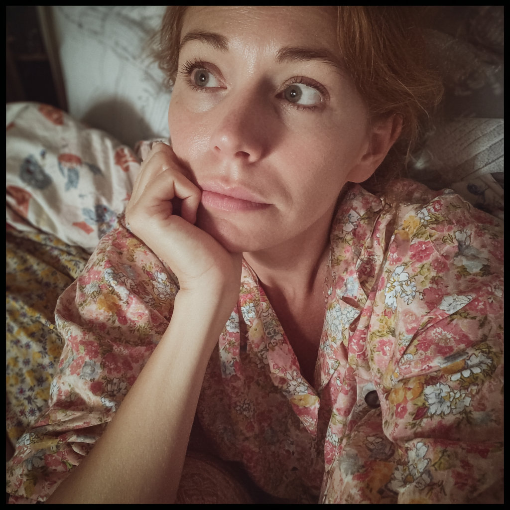 A woman sitting in her bed | Source: Midjourney